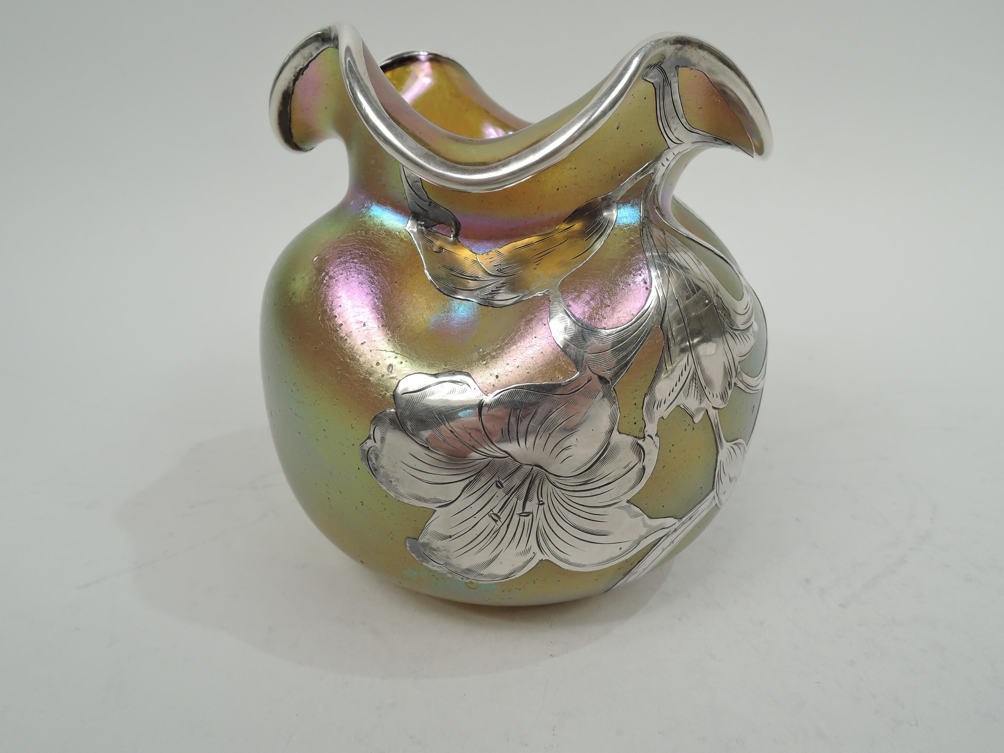 Silberiris glass vase by historic Loetz with engraved silver overlay. Globular with pinched shoulder and ruffled turned-down quatrefoil rim. On front overlay in form of loose and fluid blooms on entwined and whiplash stems. Back plain. Glass