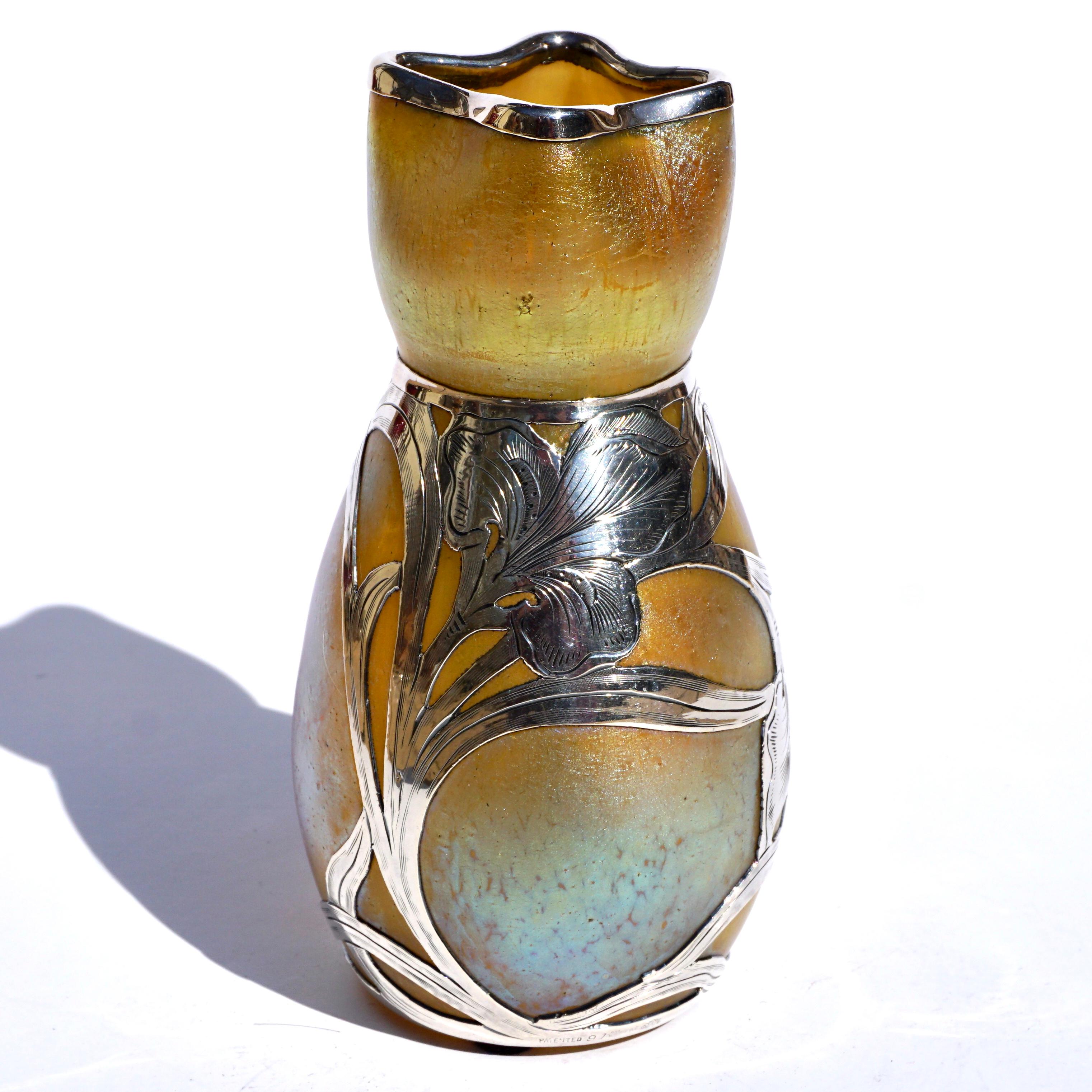 Loetz Silberiris II vase with favrile gold and blue iridescent finish. Austria Circa 1900 Art Nouveau,
Glass, sterling silver
Unmarked, numbered
Measures: Height: 5.8 Inches x 3 Inch Diameter

Mint condition, circa 1904. Silver tarnished.