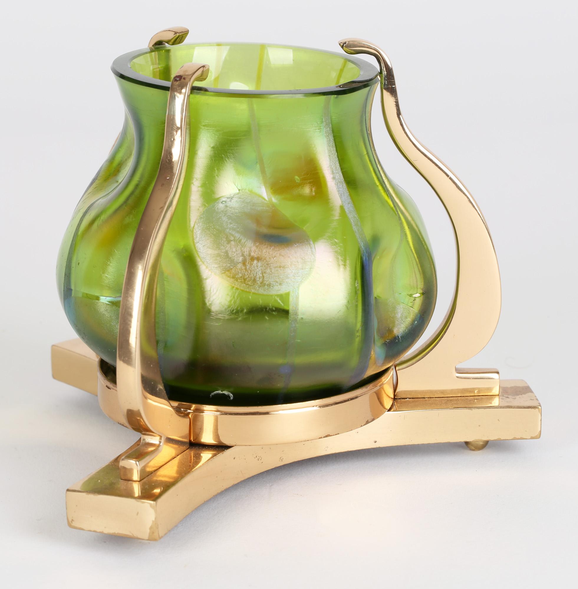 Stunning Bohemian Secessionist brass mounted glass vase with 'Streifen und Flecken' decoration by Loetz and dating from around 1900. The thickly made green glass vase has a dimpled body and decorated with subtle stripes and circle. The glass is
