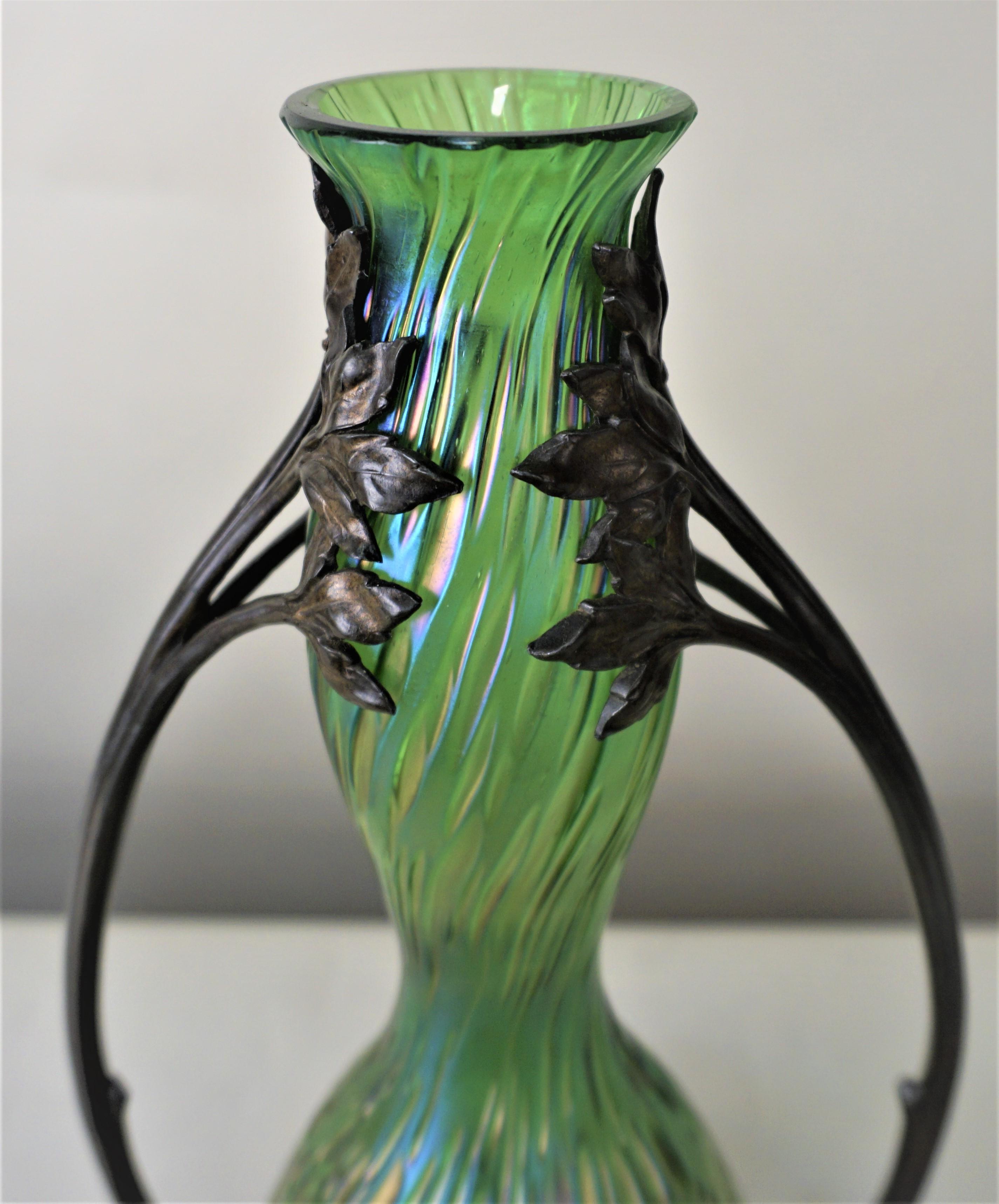 Loetz style Art Nouveau glass vase in pewter holder, iridescent glass vase with stylized leaves design on top of handles.
