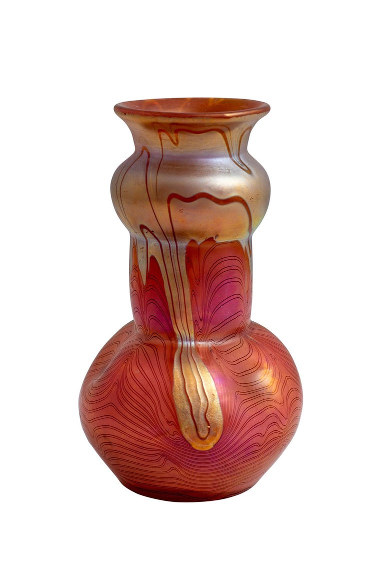 This small vase with an Unknown Phenomen Decor embodies the idea of Art Nouveau glass. Its shape could be based on the shape of a flower pistil or a calyx, thus taking account of the stylized imitation of floral-vegetable forms in Arts and Crafts