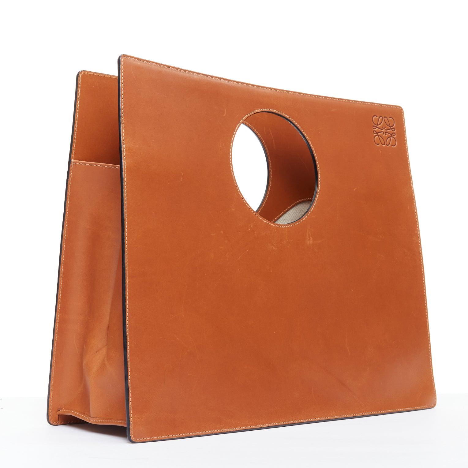 LOEWE 2015 Circle brown leather cutout Anagram rectangular tote bag
Reference: NKLL/A00368
Brand: Loewe
Collection: SS 2015 - Runway
Material: Leather
Color: Brown
Pattern: Solid
Lining: Cream Canvas
Extra Details: Loewe's tan leather 'Circle' tote.