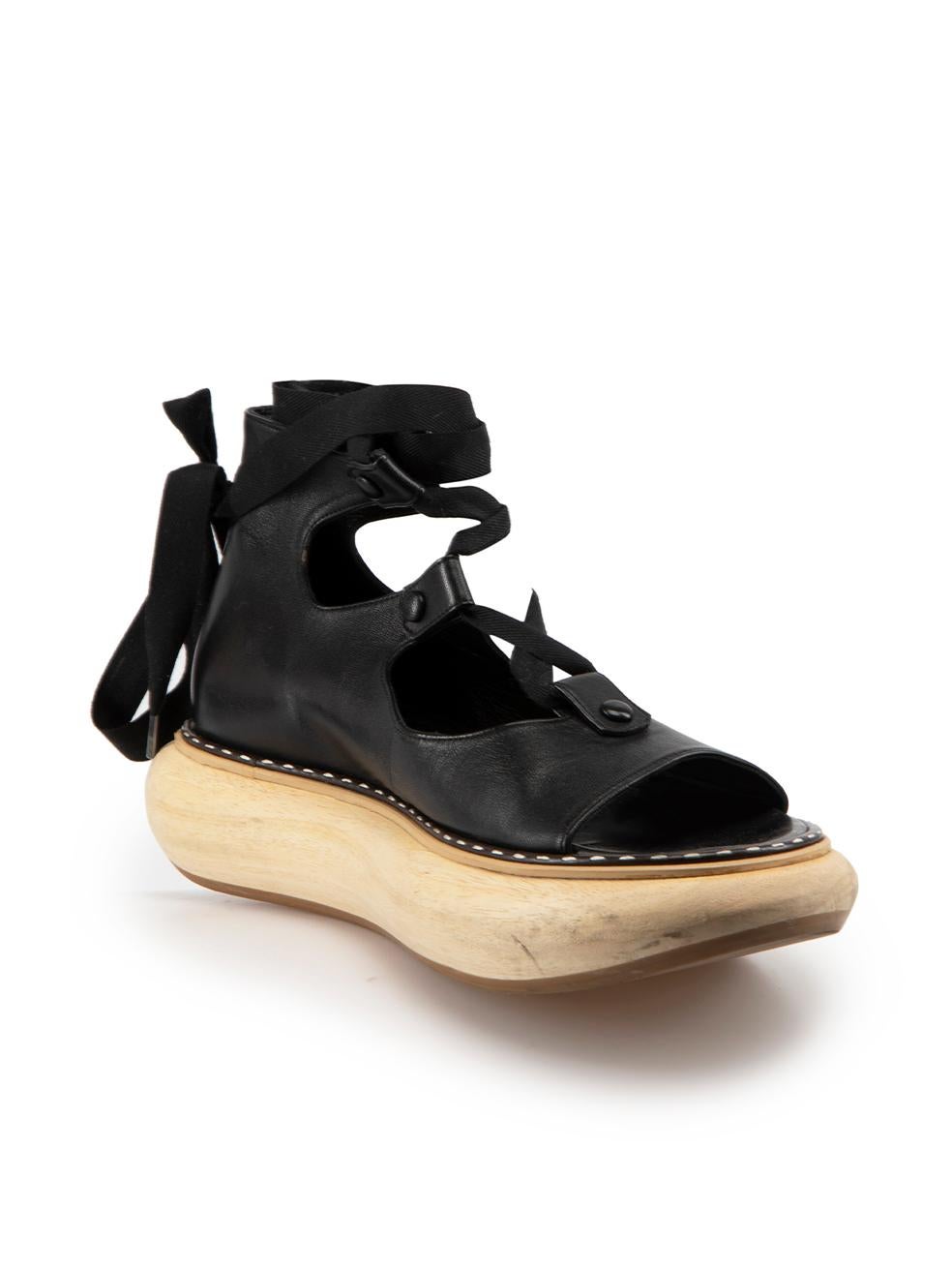 CONDITION is Good. Minor wear to sandals is evident. Light wear to wooden platform with a number of dark scuff marks seen on this used Loewe designer resale item.
  
Details
2018
Black
Leather
Sandals
Wooden platform sole
Lace up fastening
Open toe

