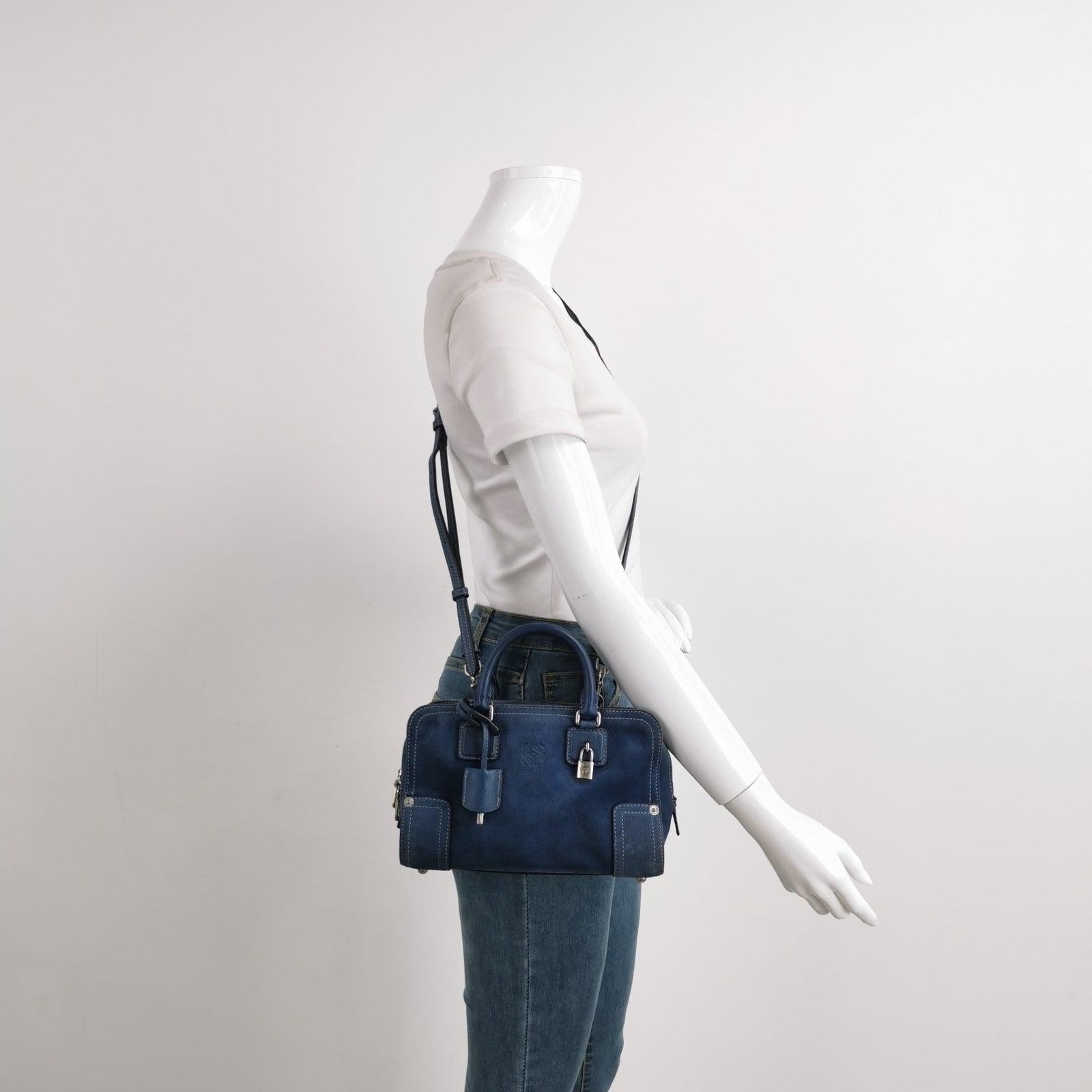 Loewe Amazona 23 in Navy Blue Suede Leather with Strap These are professional photos of the actual bag offered by Luxbags. Top handle bag in boxy trunk style is back in fashion in 2024 thanks to shows by Prada and Miumiu. The Loewe Amazona bag is a