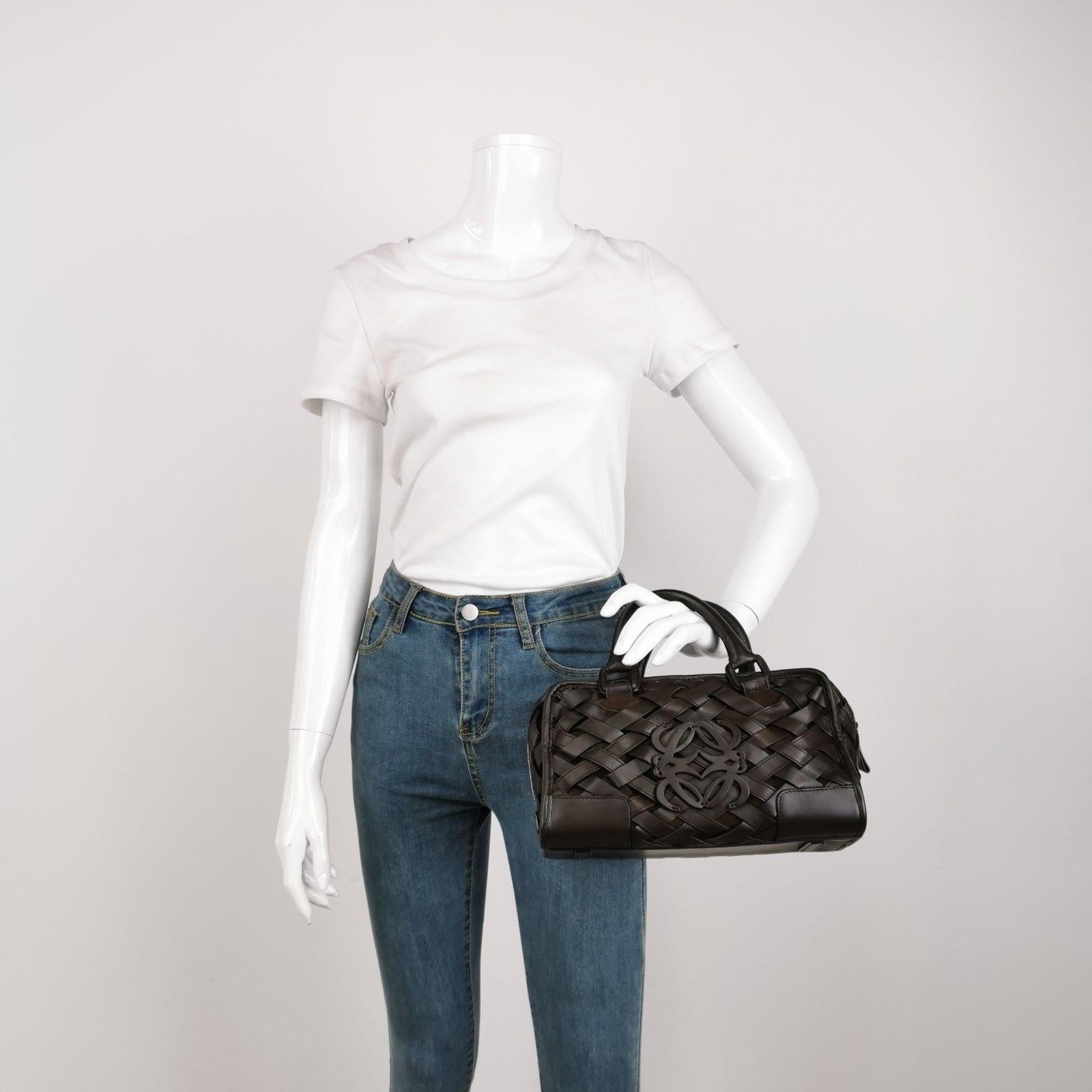 Loewe Amazona 29 in Brown Intrecciato Woven Calfskin Leather Handbag These are professional photos of the actual bag offered by Luxbags. The Loewe Amazona bag is a stylish and functional option for everyday use, with a structured yet soft shape.