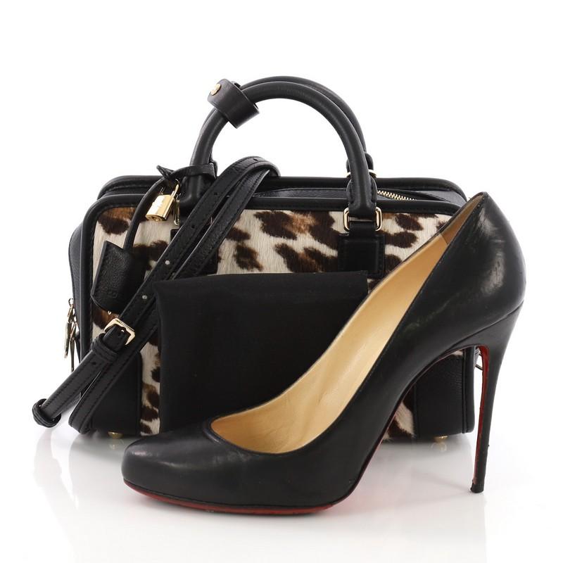 This Loewe Amazona Bag Calf Hair 23, crafted in calf hair and leather, features dual rolled leather handles, embossed logo at front, and gold-tone hardware. Its zip closure opens to a black leather interior with zip and slip pockets. **Note: Shoe
