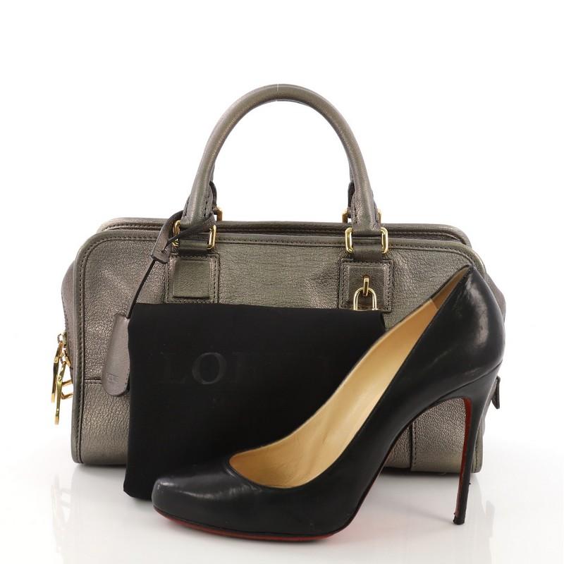 This Loewe Amazona Bag Leather 28, crafted from bronze leather, features dual rolled leather handles, embossed logo at front, and gold-tone hardware. Its zip closure opens to a black fabric interior with zip and slip pockets. **Note: Shoe
