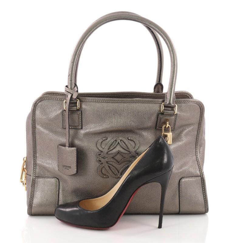 This Loewe Amazona Bag Leather 36, crafted in silver leather, features dual-rolled leather handles, embossed logo at front, and gold-tone hardware accents. Its zip closure opens to a black fabric-lined interior with slip pockets. **Note: Shoe
