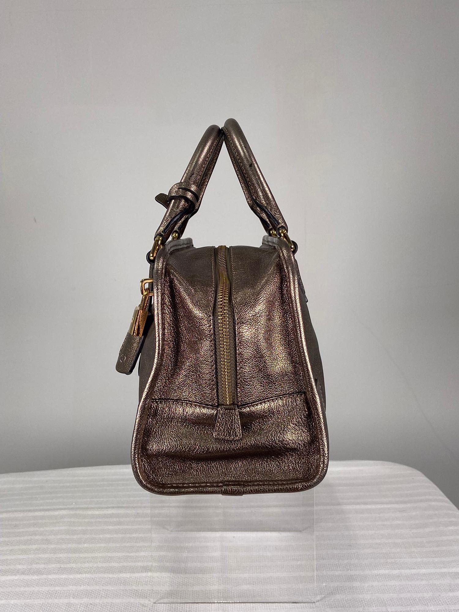 Loewe Amazona bronze goatskin handbag. Beautiful bronze metallic soft goat skin leather bag, the front features a raised logo applique, rolled leather welt around the edges. Double rolled handles with gold hardware. Lock and key cloche, zipper