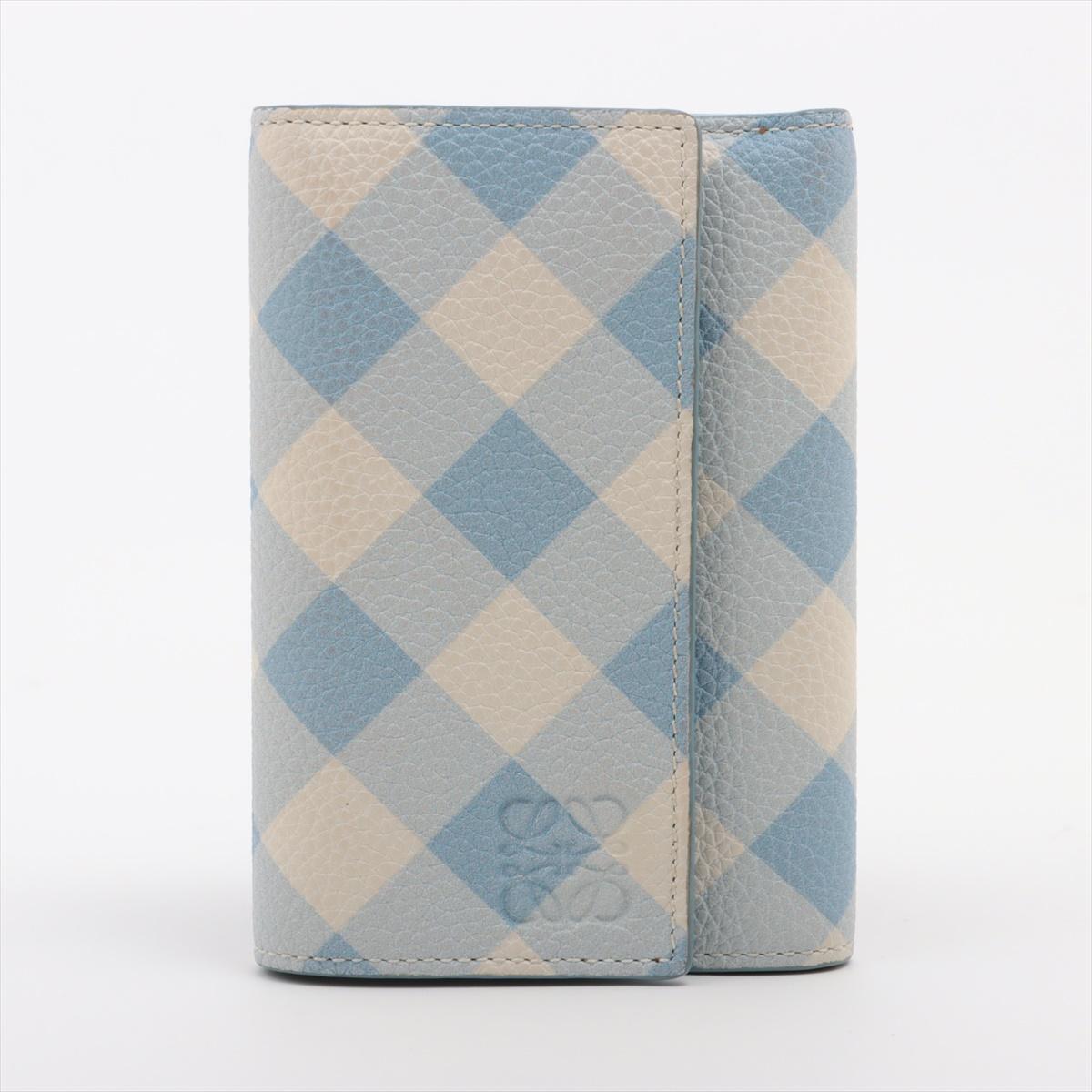 *ships about 12/11

The Loewe Anagram Leather Checkered Blue Trifold Wallet in Blue and White is a refined and stylish accessory that merges contemporary design with classic craftsmanship. Made from high-quality leather, it features a bold checkered