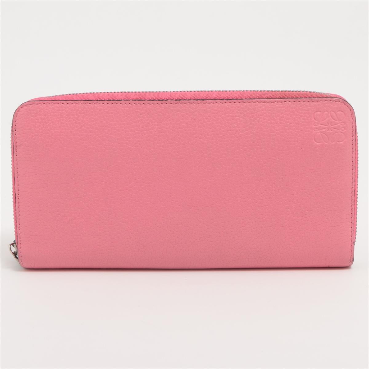 The Loewe Anagram Leather Zippy Wallet in Pink a chic and versatile accessory that seamlessly combines luxury with modern design. Meticulously crafted from smooth leather, the wallet features the iconic Loewe Anagram logo in an understated yet