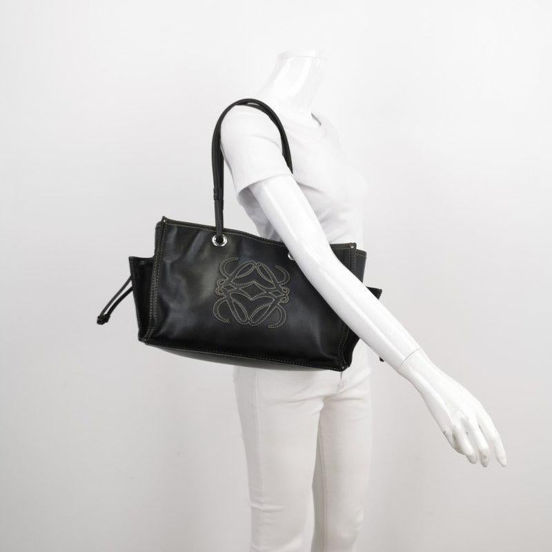 Loewe Anagram Love Logo Shopper Tote Black Medium 35cm
 These are professional photos of the actual bag.
 
 CONDITION: VERY GOOD
 Light rubbing and stains on the corners, base, zipper, straps. Cracks on the wax along the edges. Light stains on the