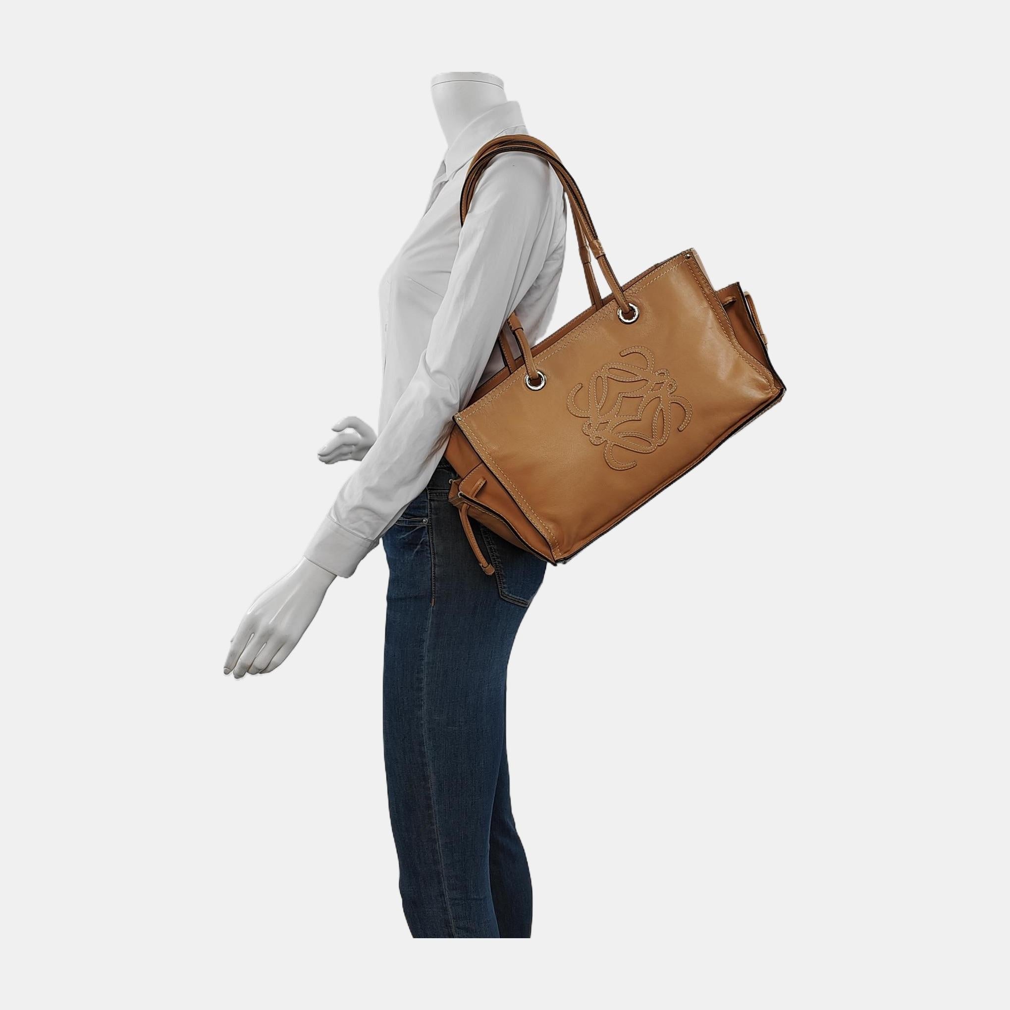 Loewe Anagram Love Logo Shopper Tote Black Medium 35cm
 These are professional photos of the actual bag.
 
 CONDITION: VERY GOOD
 Light rubbing and stains on the corners, base, zipper, straps. Cracks on the wax along the edges. Light stains on the