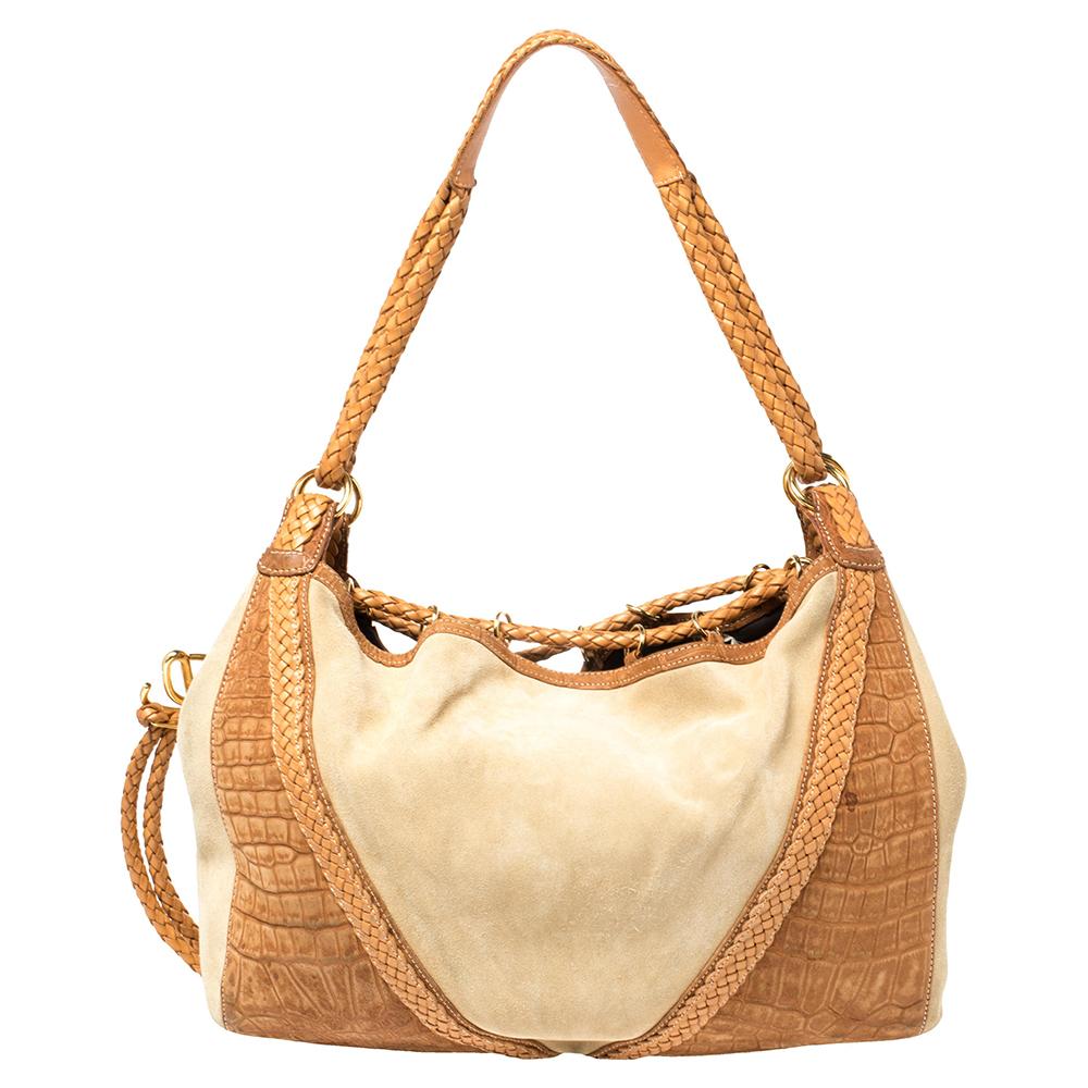 Exhibiting an up-to-date design, this hobo by Loewe has a sophisticated look. Crafted from beige and brown croc-embossed nubuck, leather, and suede and designed with braided drawstring ties and a top handle, it opens to a spacious leather interior