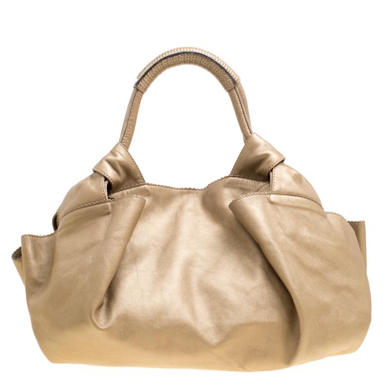 Simple and in style, this hobo from Loewe definitely needs to be in your closet. The beige hobo is crafted from Nappa leather and spells creative excellence. It features two handles and a spacious fabric interior that will hold all your daily