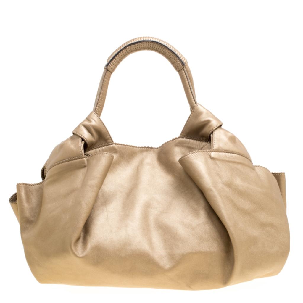 Simple and in style, this hobo from Loewe definitely needs to be in your closet. The beige hobo is crafted from Nappa leather and spells creative excellence. It features two handles and a spacious fabric interior that will hold all your daily