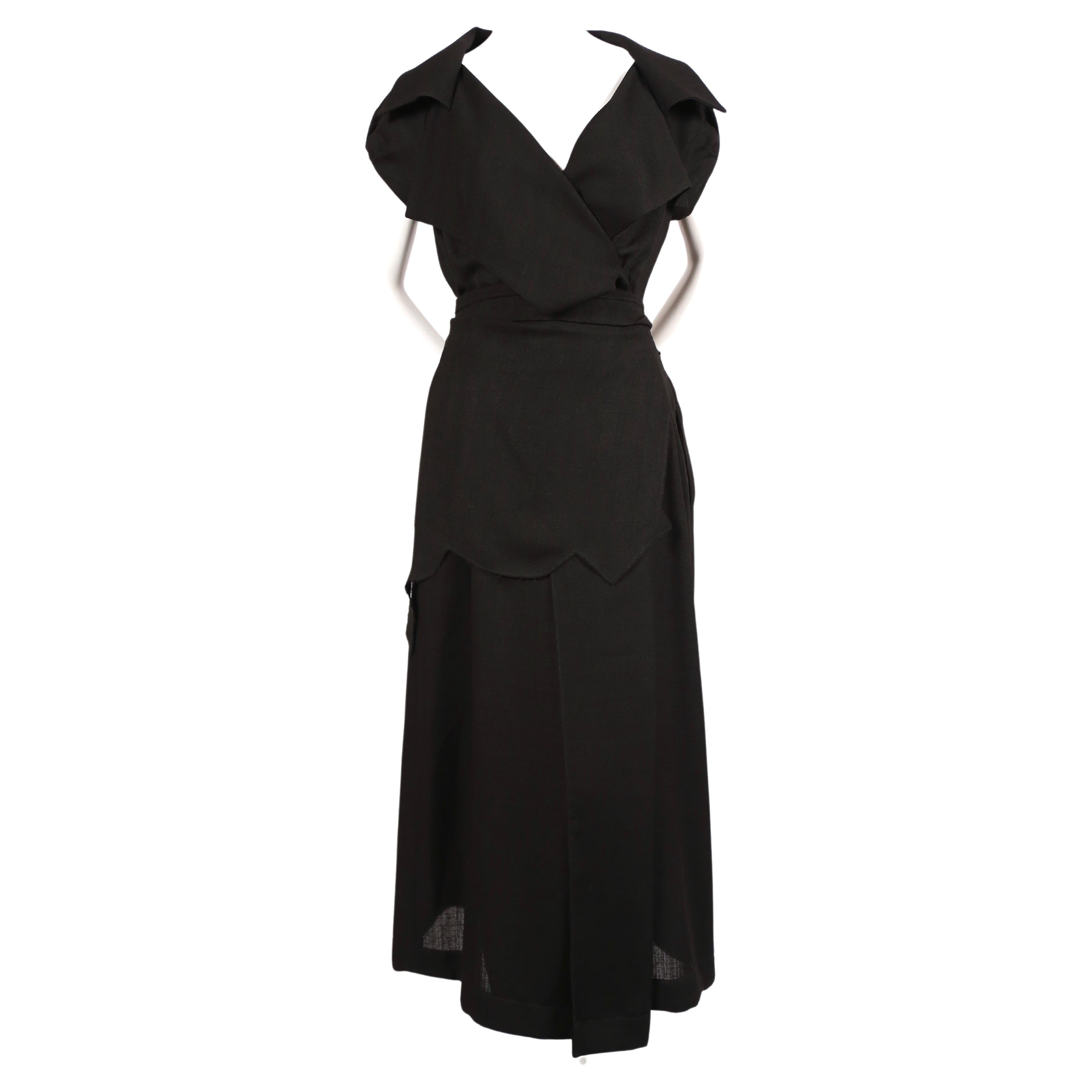 Black asymmetrical dress with raw edges and waist tie designed by Jonathan Anderson for Loewe exactly as seen on the spring 2015 runway. European size 36 which best fits a US 2-4. Approximate measurements: maximum waist 28