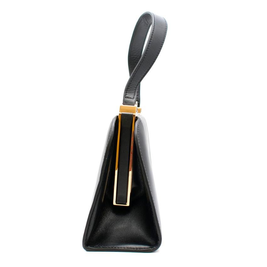 Loewe Black Lantern Bag 

Crafted from Boxcalf. Internal metal frame with a compact mirror, and compartments for essentials. Interior featuring a small flashlight to illuminate contents, and shed light to the outside through a small window. Metallic
