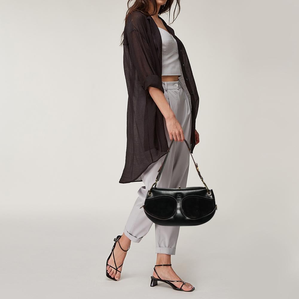 Expertly designed from leather, this bag exhibits a unique design. This bag has suede panels, zip accents, and the brand logo on the exterior. The spacious interior is lined with fabric. This Loewe handbag in black displays your fashion-forward