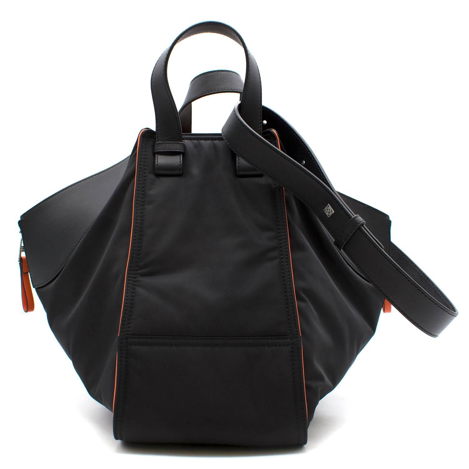 Loewe black hammock bomber bag

Featuring:
-expandable zip gusset at sides
-protective metal feet
-silvertone hardware
-lined with orange herringbone fabric
-two small interior slip pockets 
-leather handles, detachable,
adjustable strap
- front