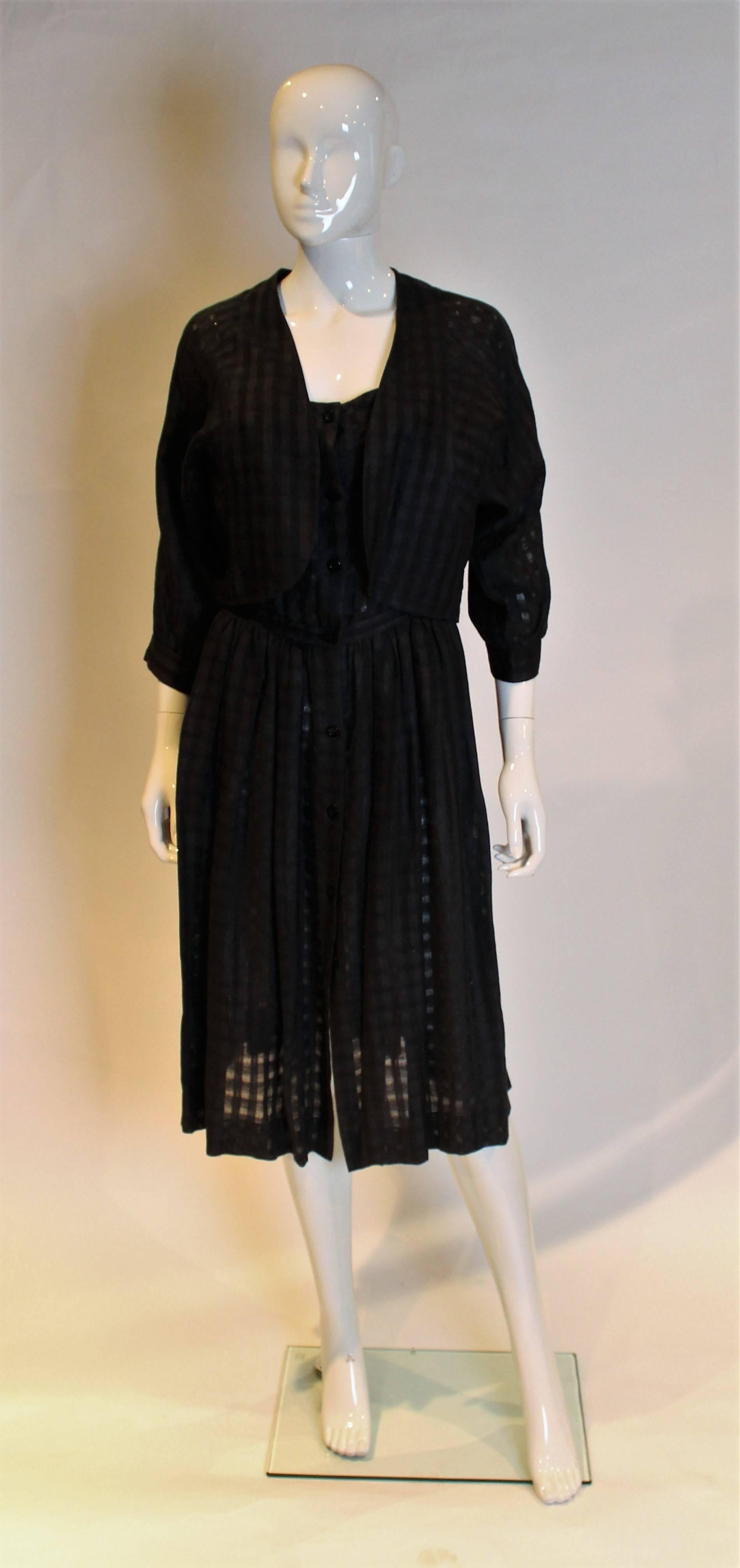 A chic sundress and jacket by Spanish designer Loewe. The dress has shoulder straps with buttons, a button through opening at the front, and a pocket on either side. The jacket has elbow length sleaves with a button fastening.

Dress: Bust: 35'',