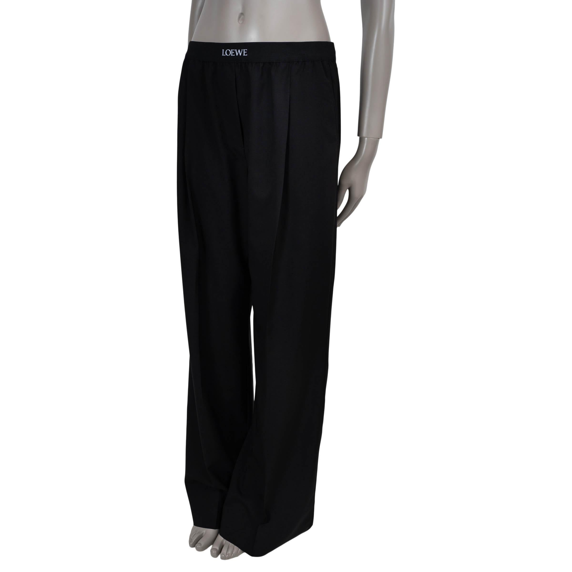 Questi pantaloni Loewe in lana nera (100%), autentici al 100%, sono realizzati in una silhouette rilassata con gambe dritte e pieghe frontali nette. Presentano due tasche laterali e una tasca posteriore, bilanciate da una fascia elastica in vita con
