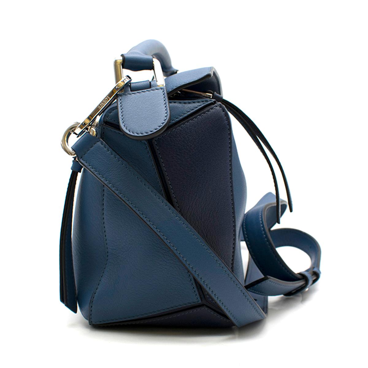 Loewe Blue Puzzle Small Bag 

- new iconic Loewe Puzzle bag
- internal details: fabric lining, internal slot pockets
- back zip pocket
- detachable shoulder strap, 
- top handle
- zipped top

This item come with the original dust bag.

Please note,