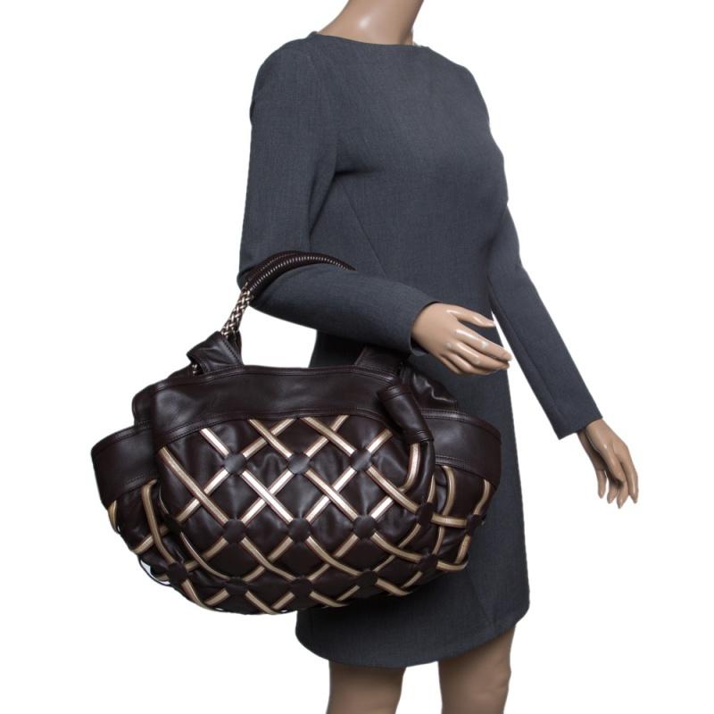 You will love this attractively fashioned bag made in a shade of brown and crafted from leather to endure. This one from Loewe is a limited edition piece that will add value to your closet. The satchel has a mesh design on the exterior, two top