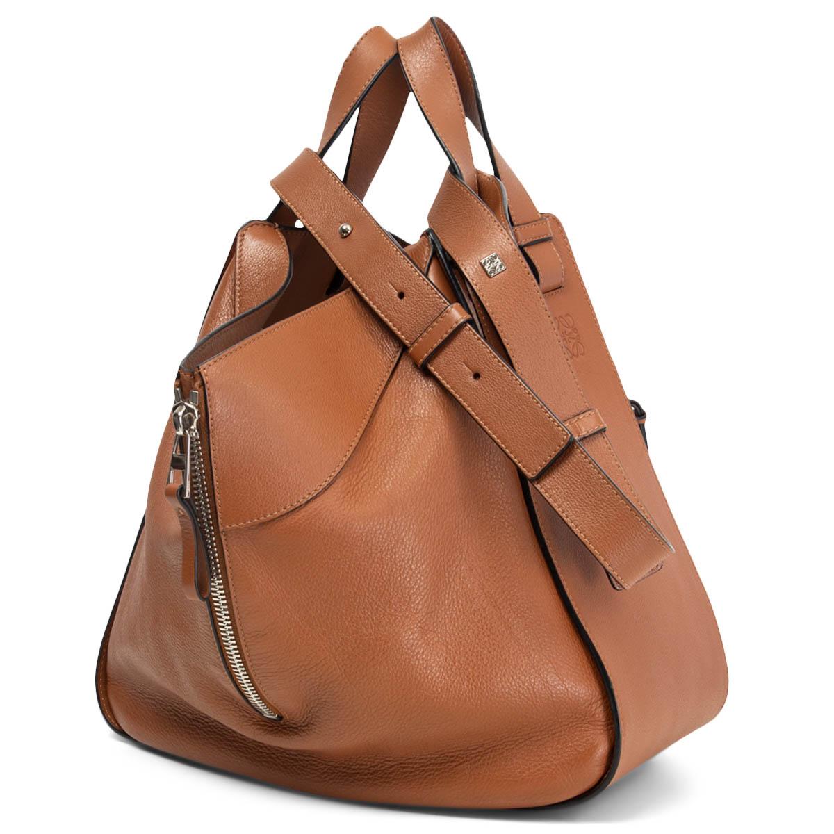 100% authentic Loewe's iconic Hammock shoulder bag in cognac brown leather and silver-tone hardware. Comes with an adjustable and detachable shoulder-strap and top-handles. Zipped sides for adjustable width and a zipped front pocket. Opens with a