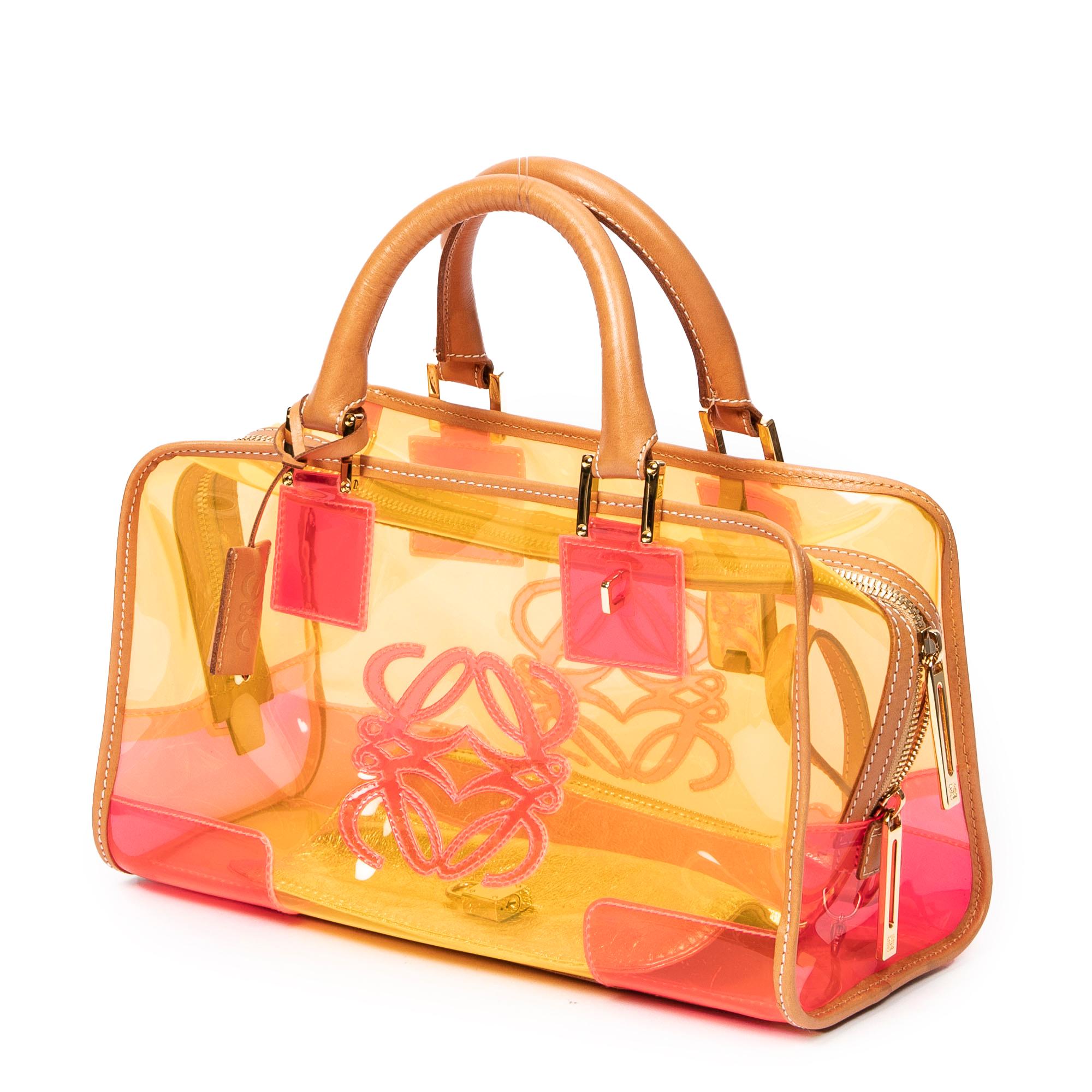 Embrace bold fashion with the Coral Pink Primavera/Verano 2008 Amazona. The coral pink PVC and gold accents catch attention, while the removable pouch within the PVC interior adds practicality. Loewe's signature creativity is epitomized in this