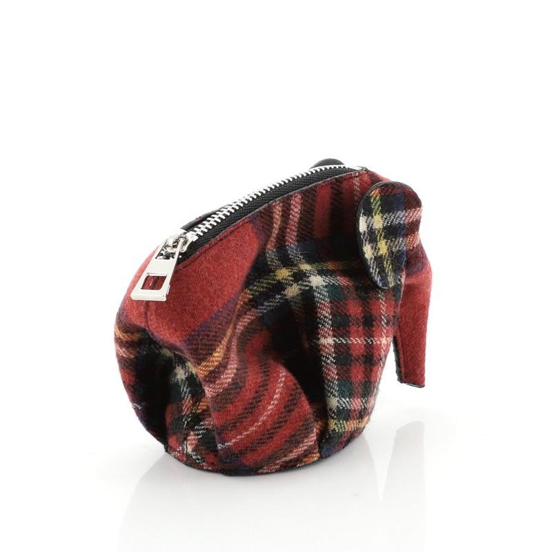 This Loewe Elephant Coin Purse Tartan Wool, crafted in red multicolor wool, features an elephant shape design, and silver-tone hardware. Its zip closure opens to a black leather interior. 

Condition: Excellent. Faint wear on leather trims,