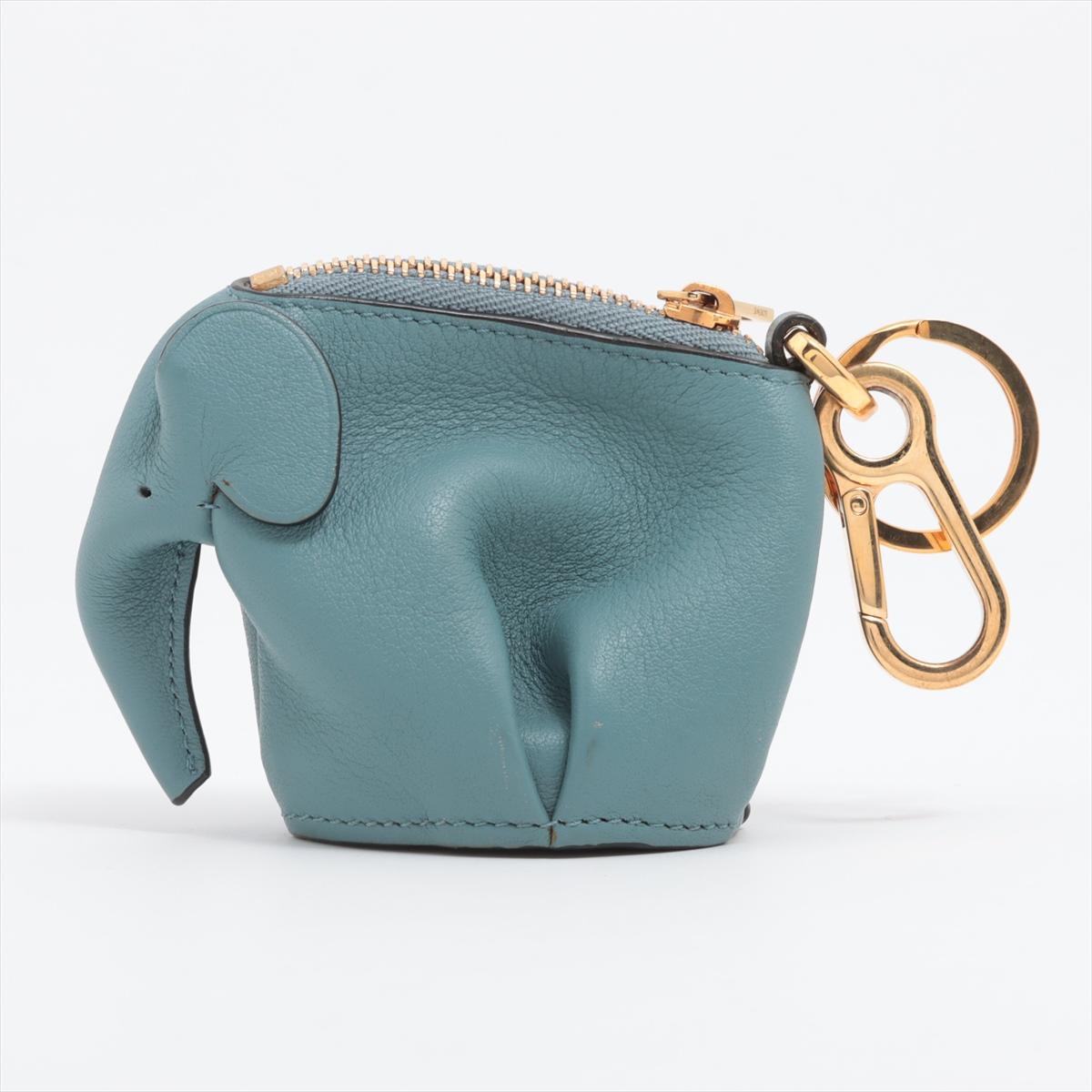 The Loewe Elephant Leather Coin Purse Bag Charm in Blue is a whimsical and charming accessory that showcases Loewe's playful design aesthetic. Crafted from high-quality leather, the coin purse takes the shape of an adorable elephant, reflecting the