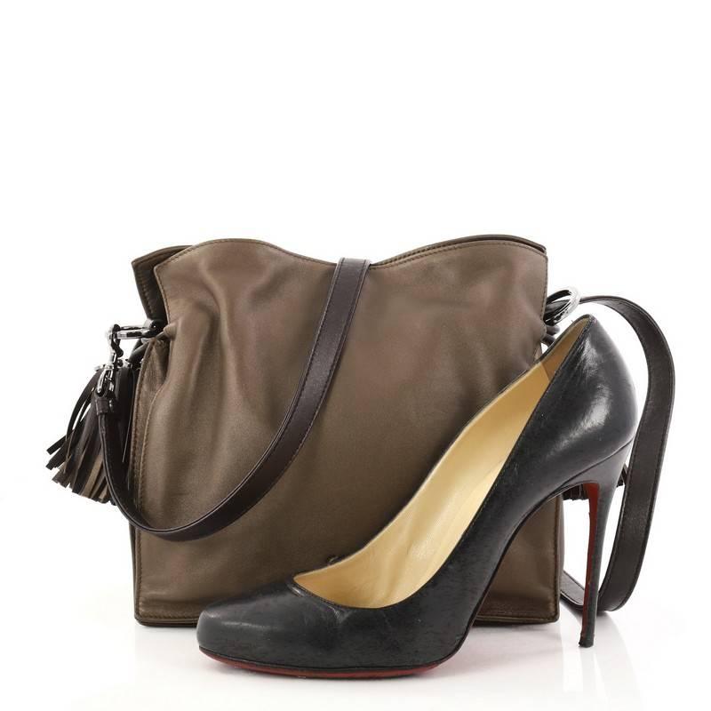 This authentic Loewe Flamenco Bag Leather is simply a must-have for your wardrobe. Crafted in taupe leather, this classy stylish bag features leather shoulder strap, drawstring top with oversized tassels, and silver-tone hardware accents. Its