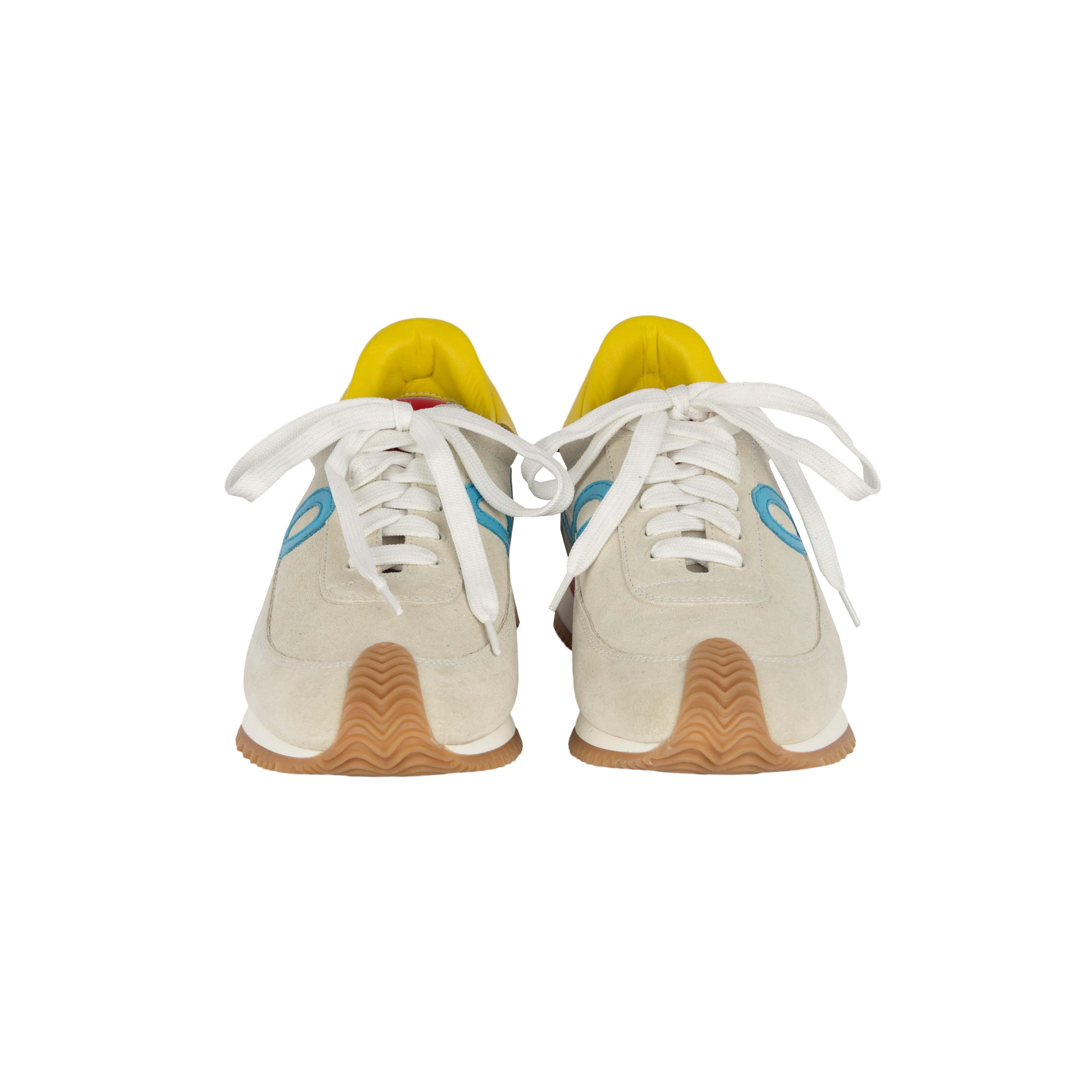 Made in Italy, the Loewe Flow Runner Sneakers has a grey canvas features the monogram etched on the red label on the tongue of the shoe, a cursive L shape depicting the brand and a pop of bright color with the yellow patch.

Insole Length - 26