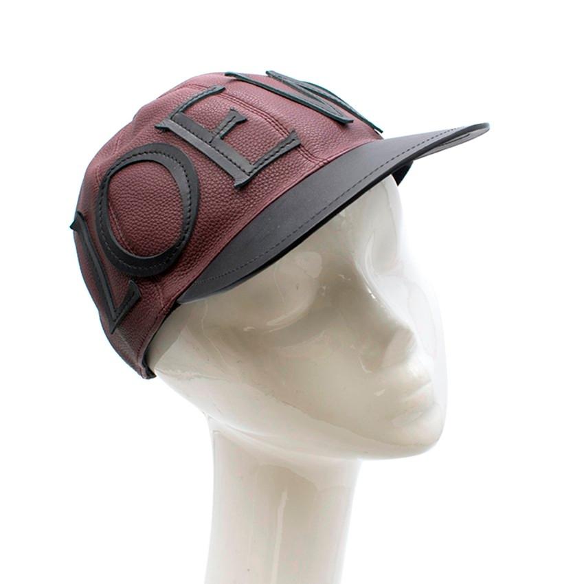 Loewe Logo Leather Lace-Up Baseball Cap

- Loewe baseball cap
- Two-tone - textured burgandy and smooth black leather
- Lace-up back with contrast white laces
- Loewe logo embossed at the back
- Loewe appliqued across the front
- Black chevron weave