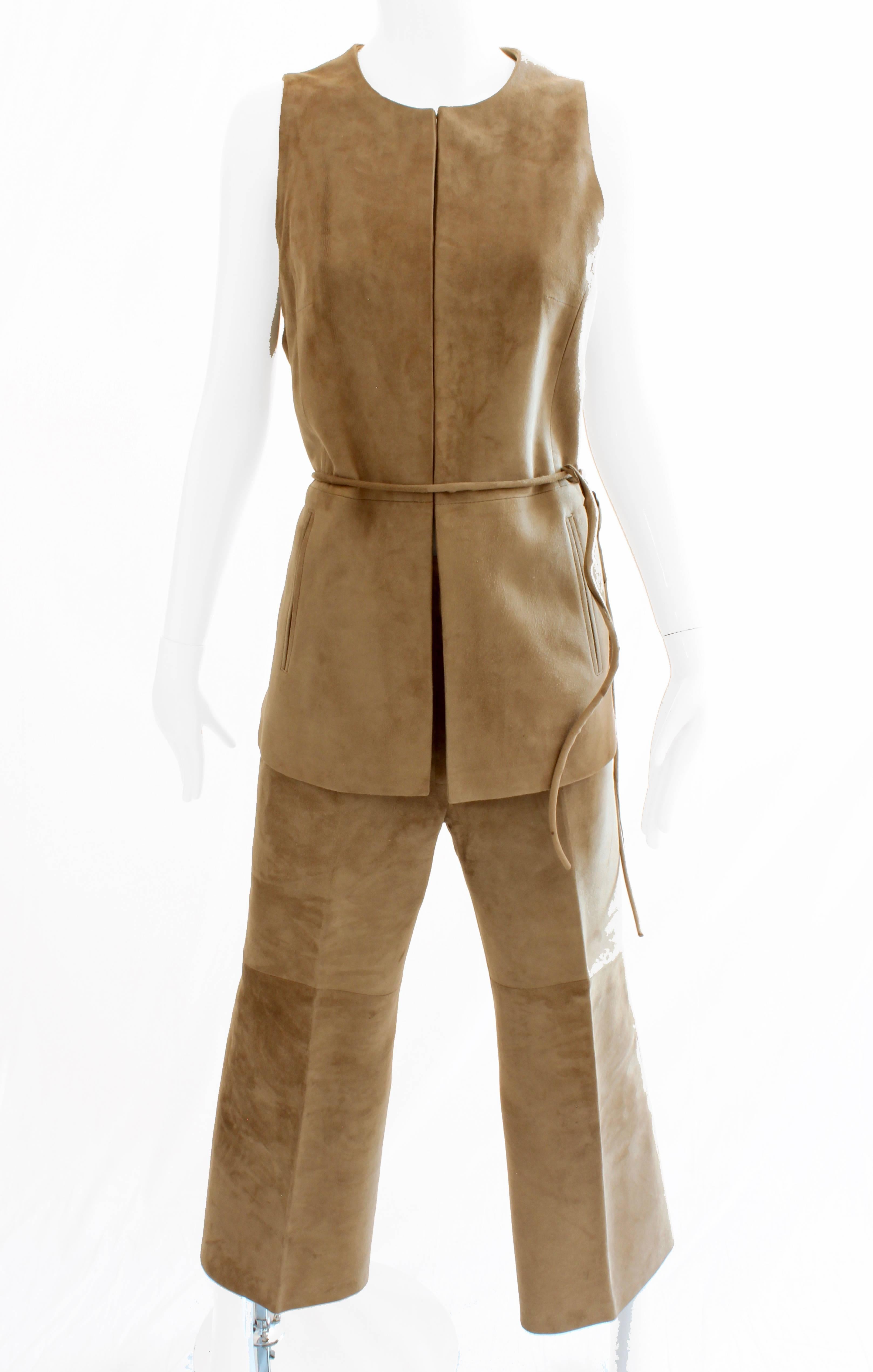 This three piece suede leather set was made by LOEWE MADRID, founded in 1846 and known for their quality leather goods.  This set includes a long suede vest, which fastens with hook/eye closures, a pair of cropped suede pants and a rope-style sueded