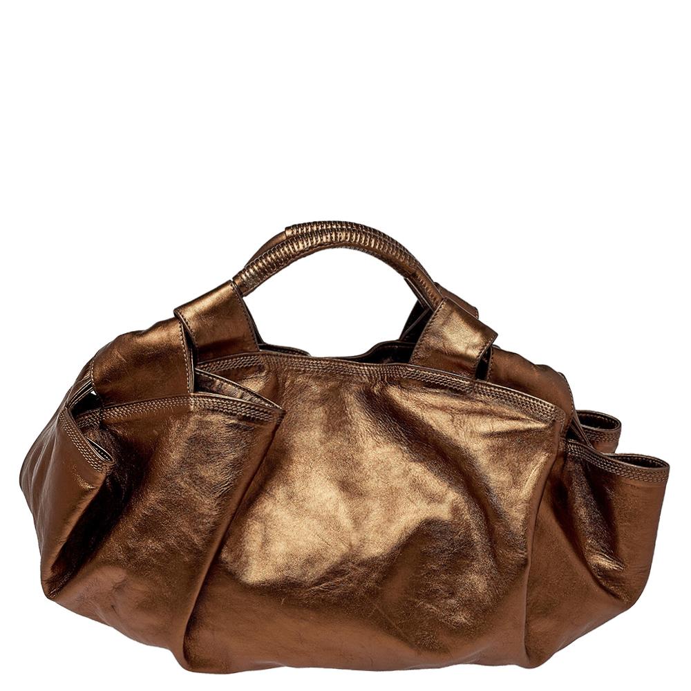 Expertly designed, flaunt a Loewe hobo bag this season. It is made from fine leather in a metallic bronze shade and is complete with a nylon interior and two handles. Give yourself a regal look with this creation and flaunt your style statement.

