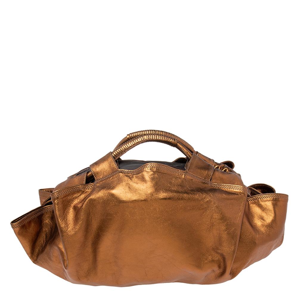 This lovely Aire hobo by Loewe will lend a stylish accent to your look of the day. It features a metallic bronze leather exterior, a fabric interior, gold-tone hardware, and two short handles on top,

