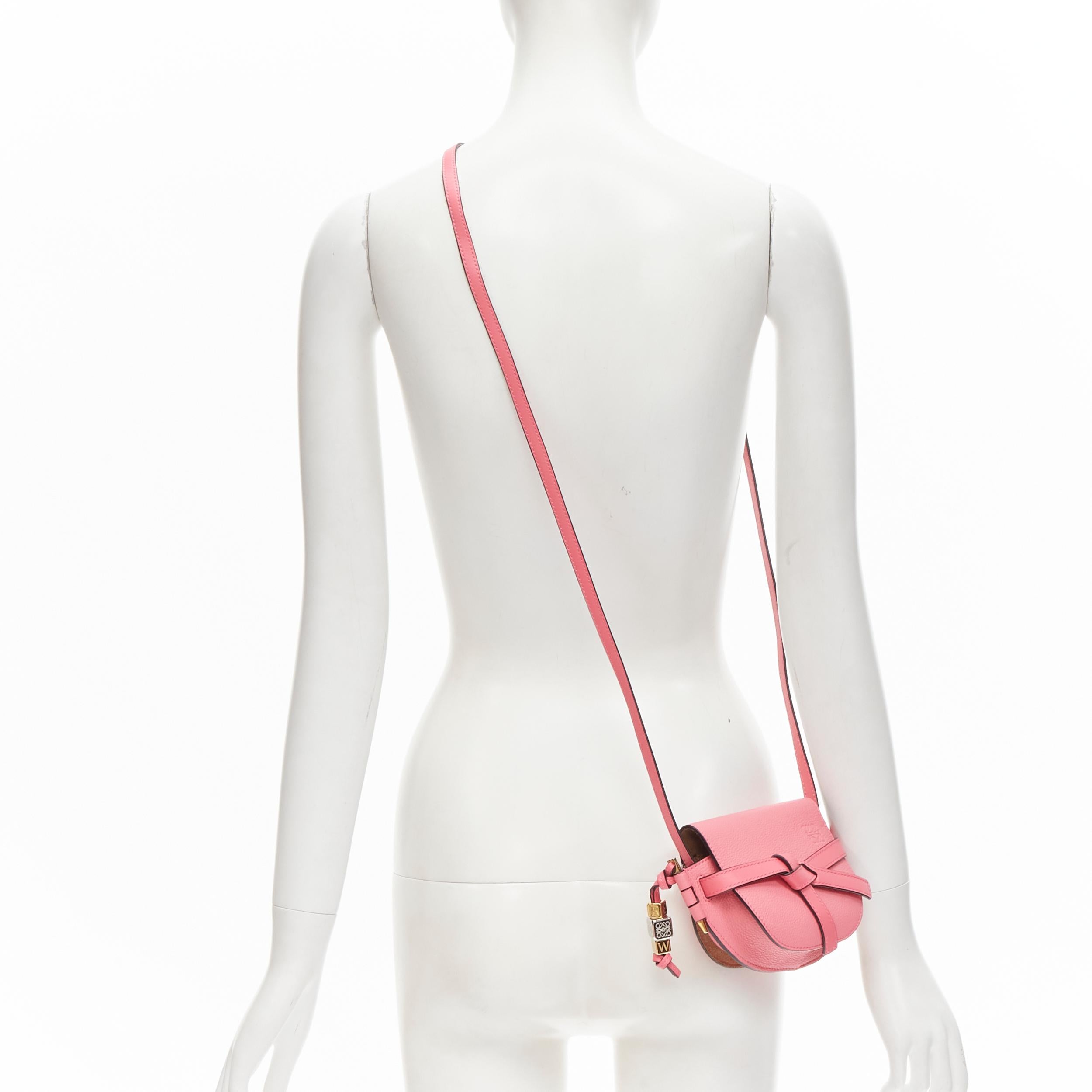 LOEWE Mini Gate light pink knot strap half moon crossbody bag 
Reference: ANWU/A00048 
Brand: Loewe 
Designer: JW Anderson 
Model: Mini Gate 
Material: Leather
Color: Pink 
Pattern: Solid 
Extra Detail: Pink leather with gold-tonehardware. LOEWE