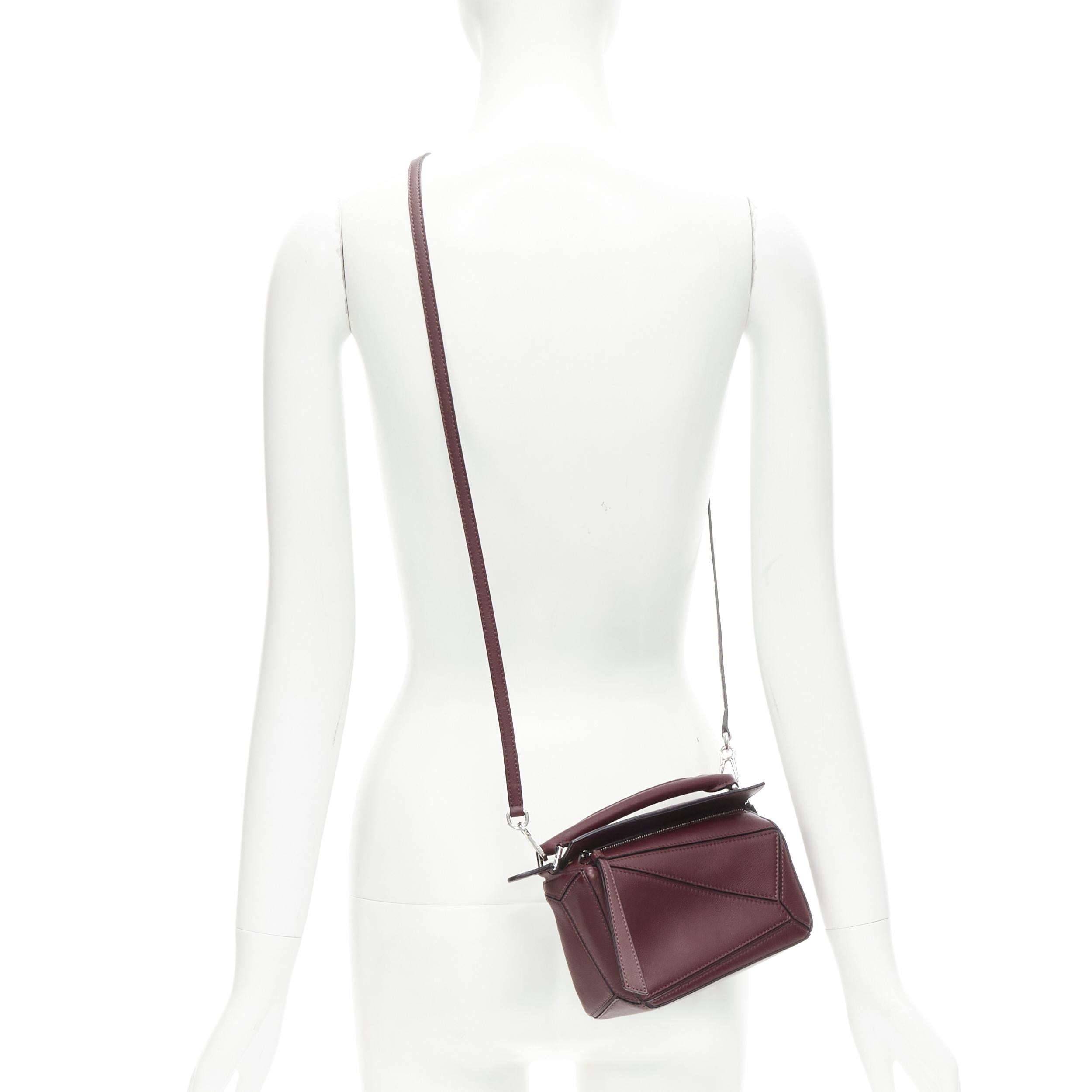 LOEWE Mini Puzzle burgundy red leather 2 way crossbody bag 
Reference: LNKO/A02000 
Brand: Loewe 
Designer: JW Anderson 
Model: Mini Puzzle 
Material: Leather 
Color: Burgundy 
Pattern: Solid 
Closure: Zip 
Extra Detail: Silver-tone hardware.