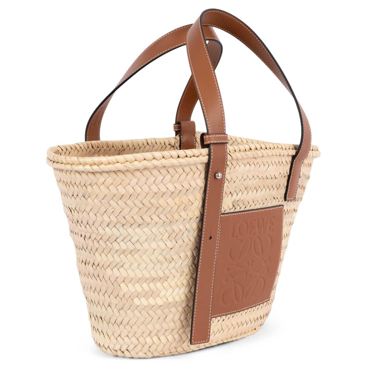 100% authentic Loewe basket medium tote in palm leaf and cognac brown calfskin with logo embossed front patch. Unlined. Has been carried once or twice and is in virtually new condition. 

Measurements
Height	24cm (9.4in)
Width	24cm