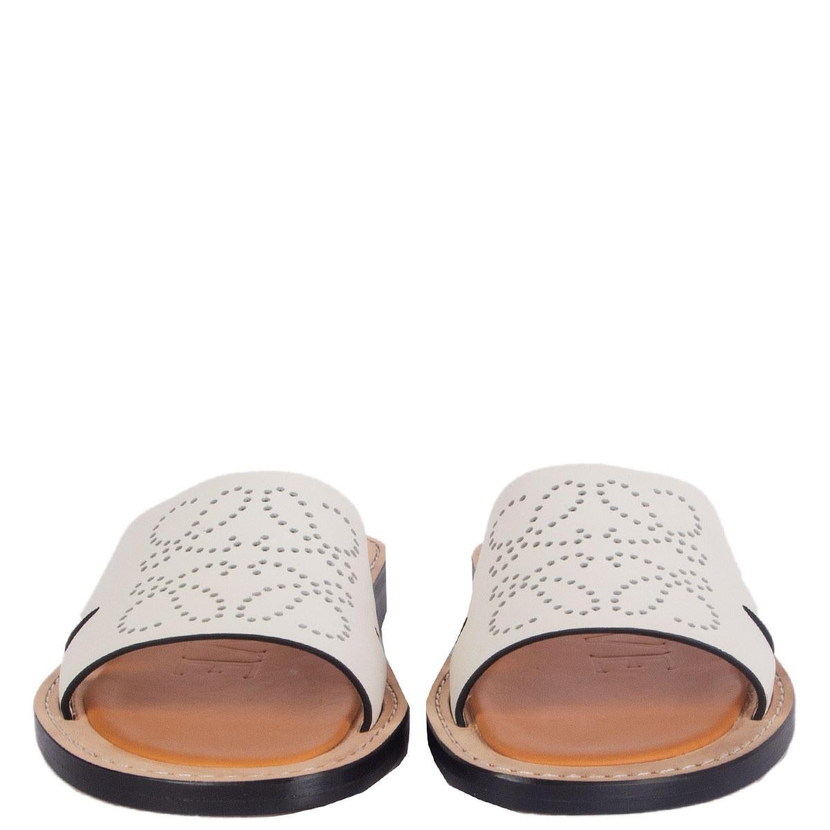 100% authentic Loewe Perforated Anagram mule flats in off-white leather and a beige leather sole. Brand new. Come with dust bag. 

Measurements
Imprinted Size	37
Shoe Size	37
Inside Sole	24cm (9.4in)
Width	8cm (3.1in)
Heel	2cm (0.8in)

All our