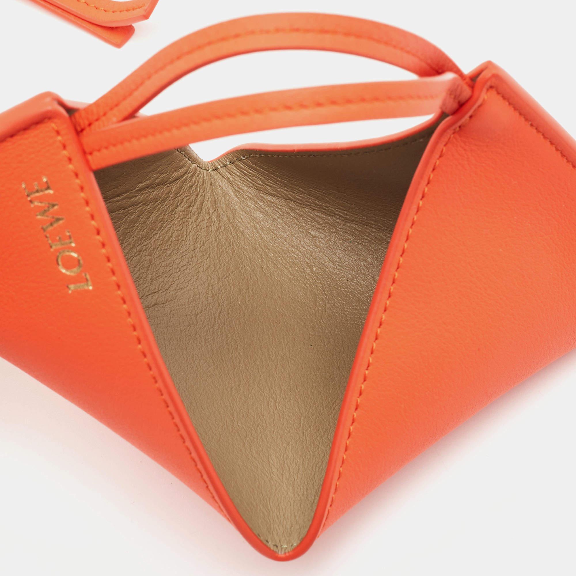 Crafted by Loewe, the charm exudes elegance and playfulness. Its supple leather, in vibrant orange hue, intricately folds into the iconic puzzle design. This petite charm is a testament to impeccable craftsmanship, adding a touch of sophistication