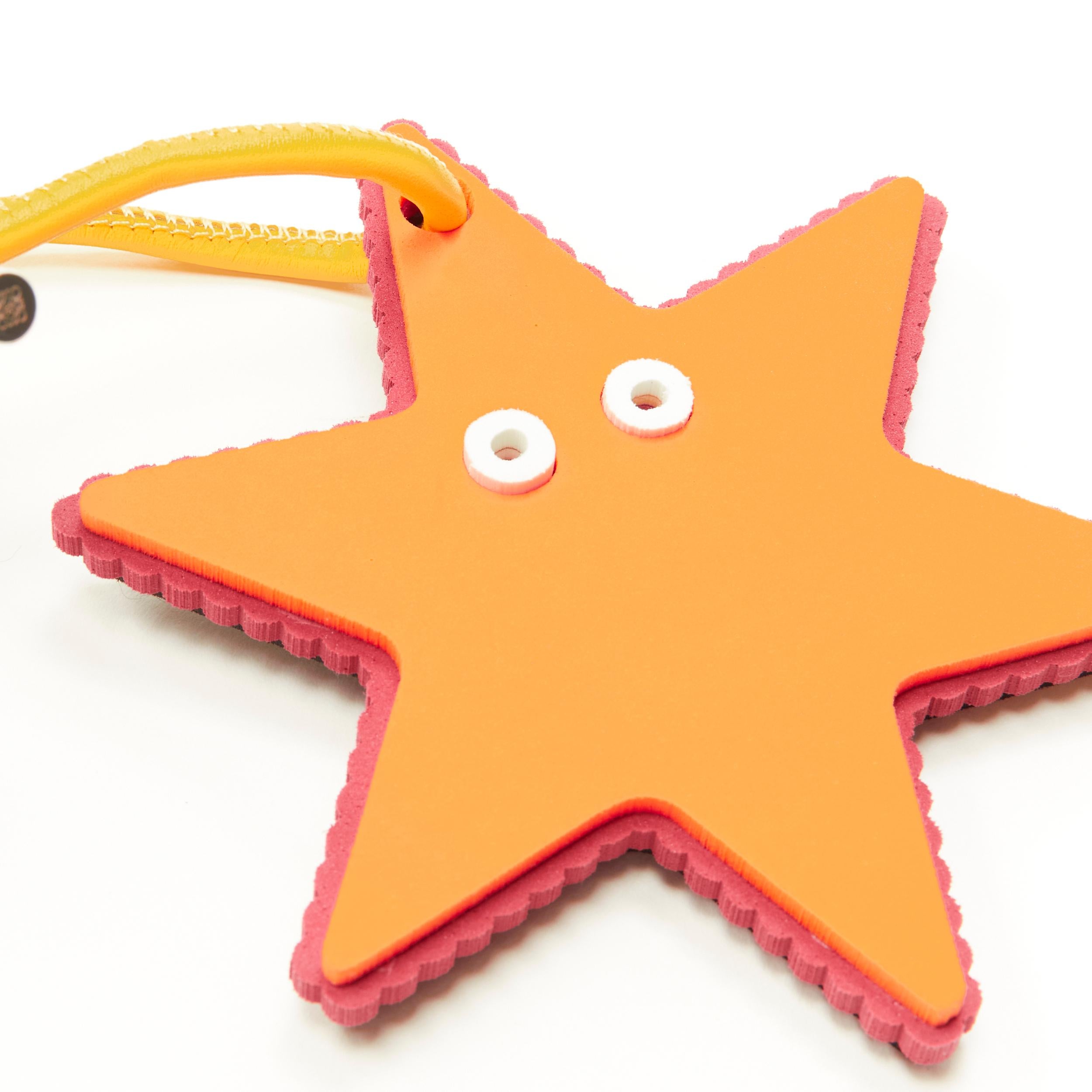 LOEWE orange starfish foam yellow leather cord bag charm 
Reference: ANWU/A00107 
Brand: Loewe 
Designer: JW Anderson 
Material: Foam 
Color: Orange 
Pattern: Solid 
Closure: Tie 
Extra Detail: Styrofoam charm with leather cord self tie strap.