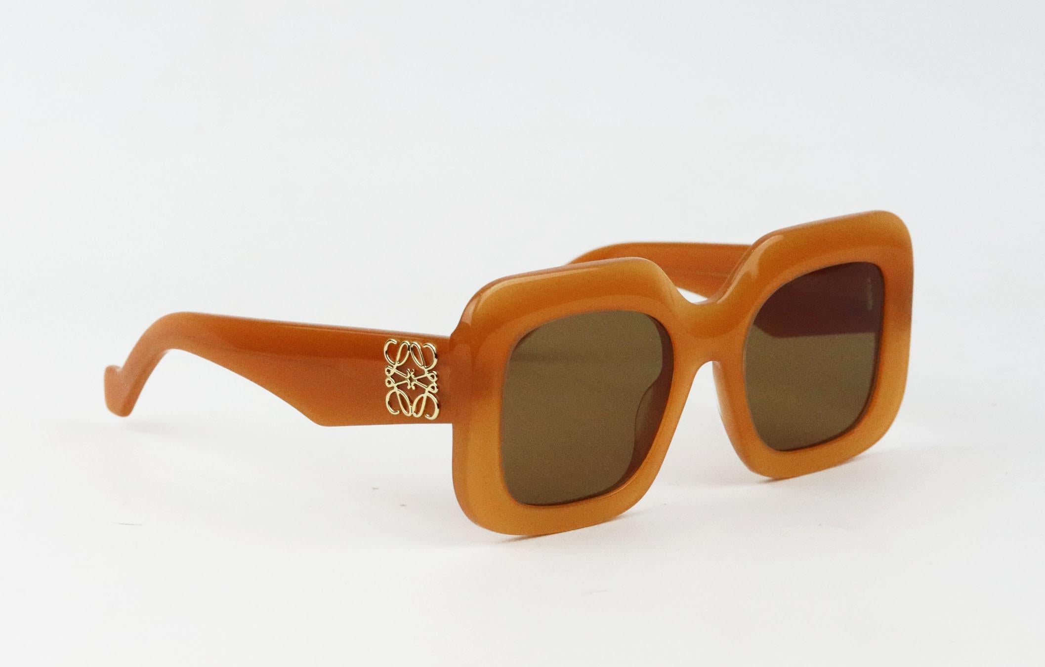 Loewe's accessories are as recognizable as its cult bags - these sunglasses are detailed with the brand's gold 'Anagram' hardware at the temples, they've been made in Italy from glossy amber-toned acetate with oversized square frames that'll suit