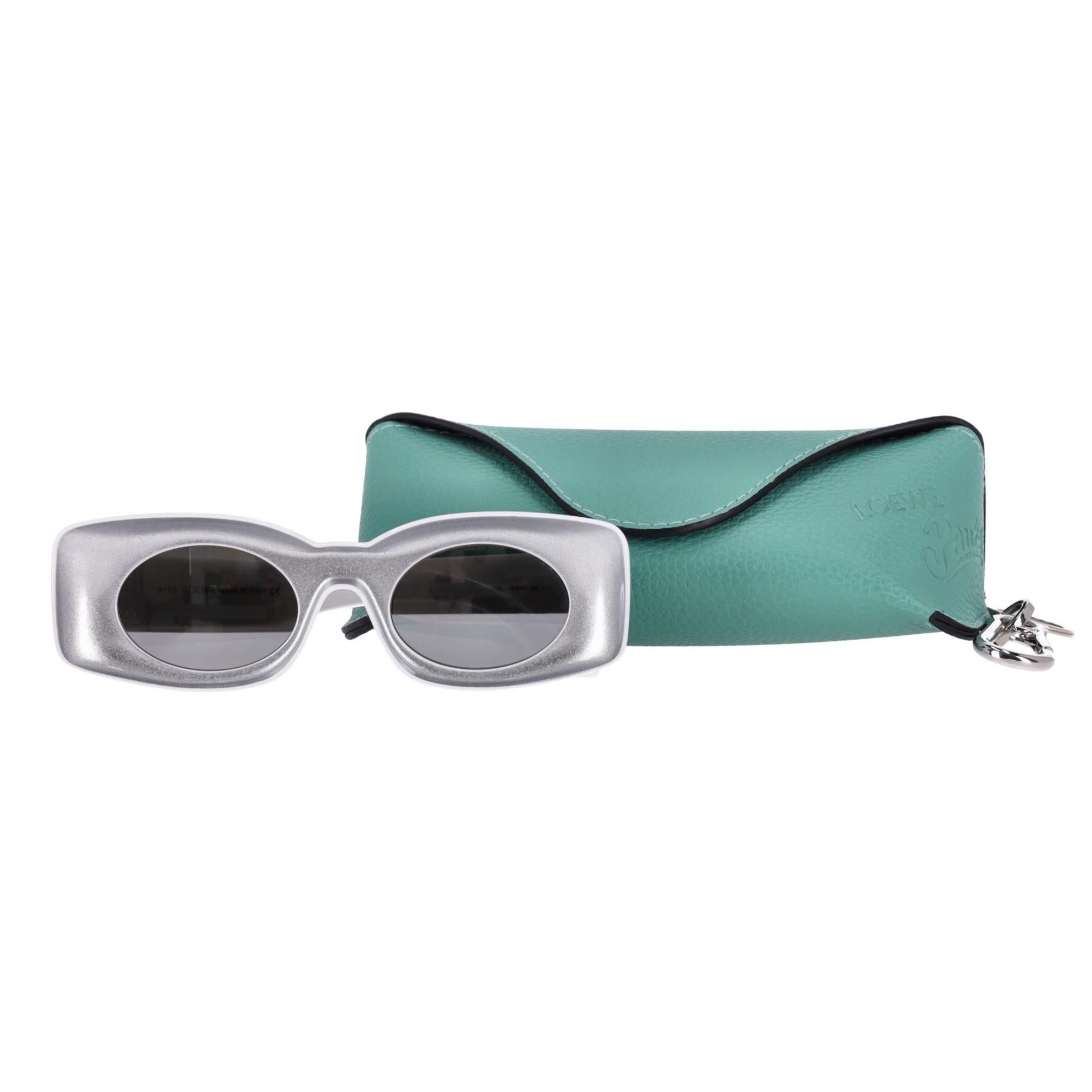 Loewe Paula's Ibiza Sunglasses

Rectangular, thick-rimmed silver sunglasses with mirrored silver-tone lenses.

Wide, white arms with 'Loewe' signature and logo printed temple tips.

Rrp Approx. £300

Size – One Size

Condition – Very