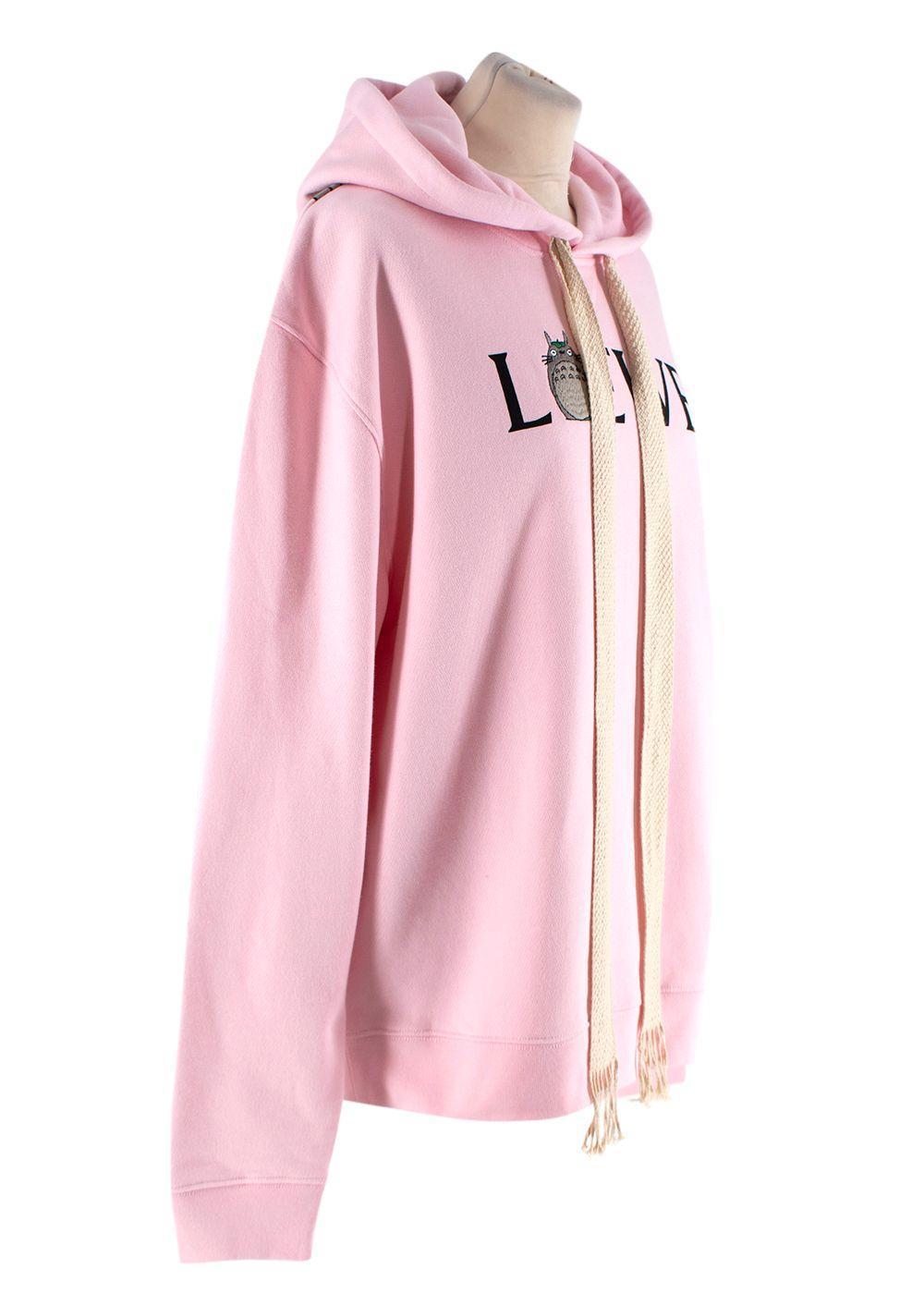 Loewe Pink Cotton My Neighbor Totoro Logo Hoodie

- Limited edition capsule
- Signature logo embroidered hoodie featuring My Neighbor Totoro motifs
- Warm light pink hue
- Thick, exaggerated drawstrings
- Large printed motif across the