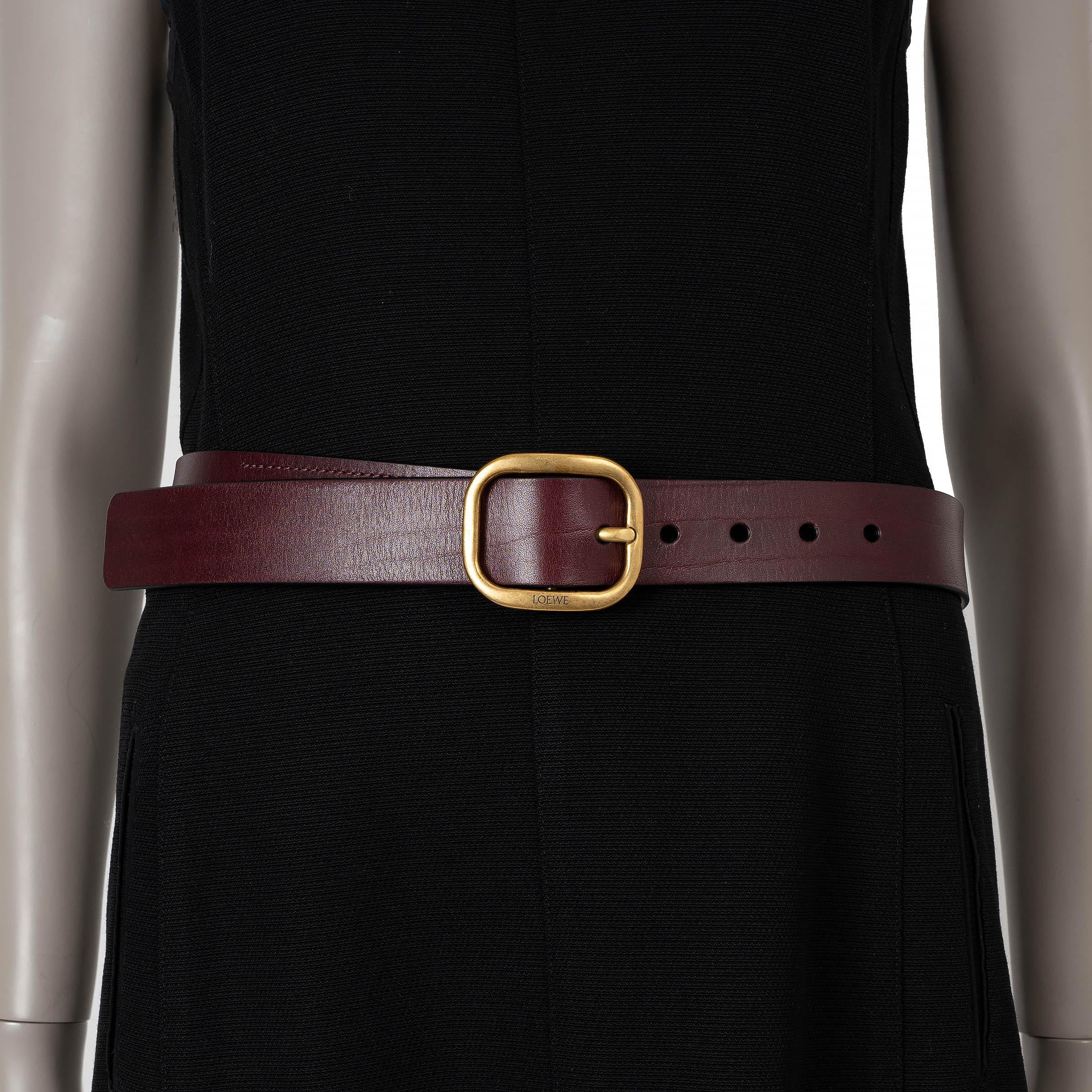 This 100% authentic Loewe belt in Prugunda (eggplant) soft leather combines understated elegance with a touch of signature style. Featuring a rounded antique gold-tone metal buckle with Loewe's iconic engraving, it is a versatile accessory perfect