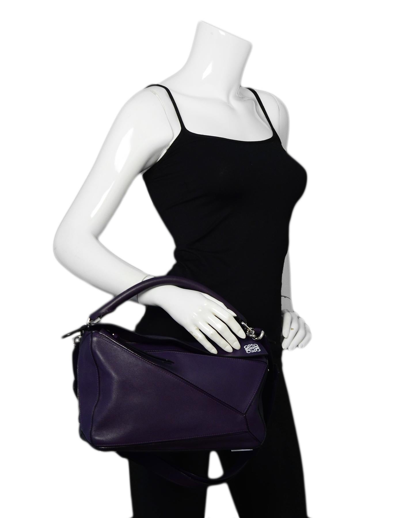 Loewe Purple Calfskin Leather Medium Puzzle Shoulder Bag w/ Crossbody Strap

Made In: Spain
Color: Purple
Hardware: Silvertone hardware
Materials: Calfskin leather
Lining: Beige textile lining
Closure/Opening: Top flap with zip closure
Exterior