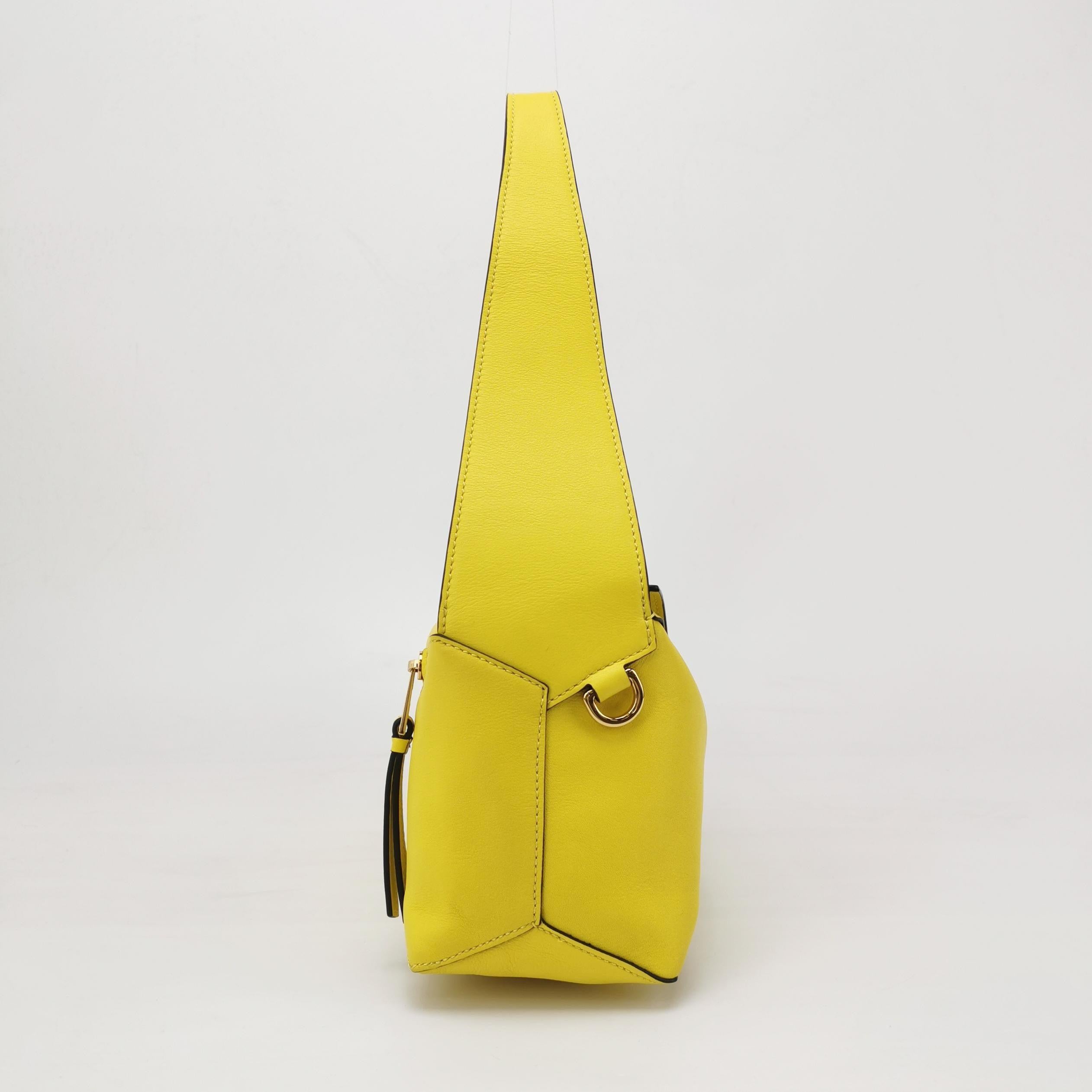 Loewe Puzzle Hobo Yellow Leather Shoulder Bag
 These are professional photos of the actual bag .
 
 This is from the sell-out collaboration between Loewe and the Japanese anime studio Studio Ghibli. This particular mini puzzle bag features a